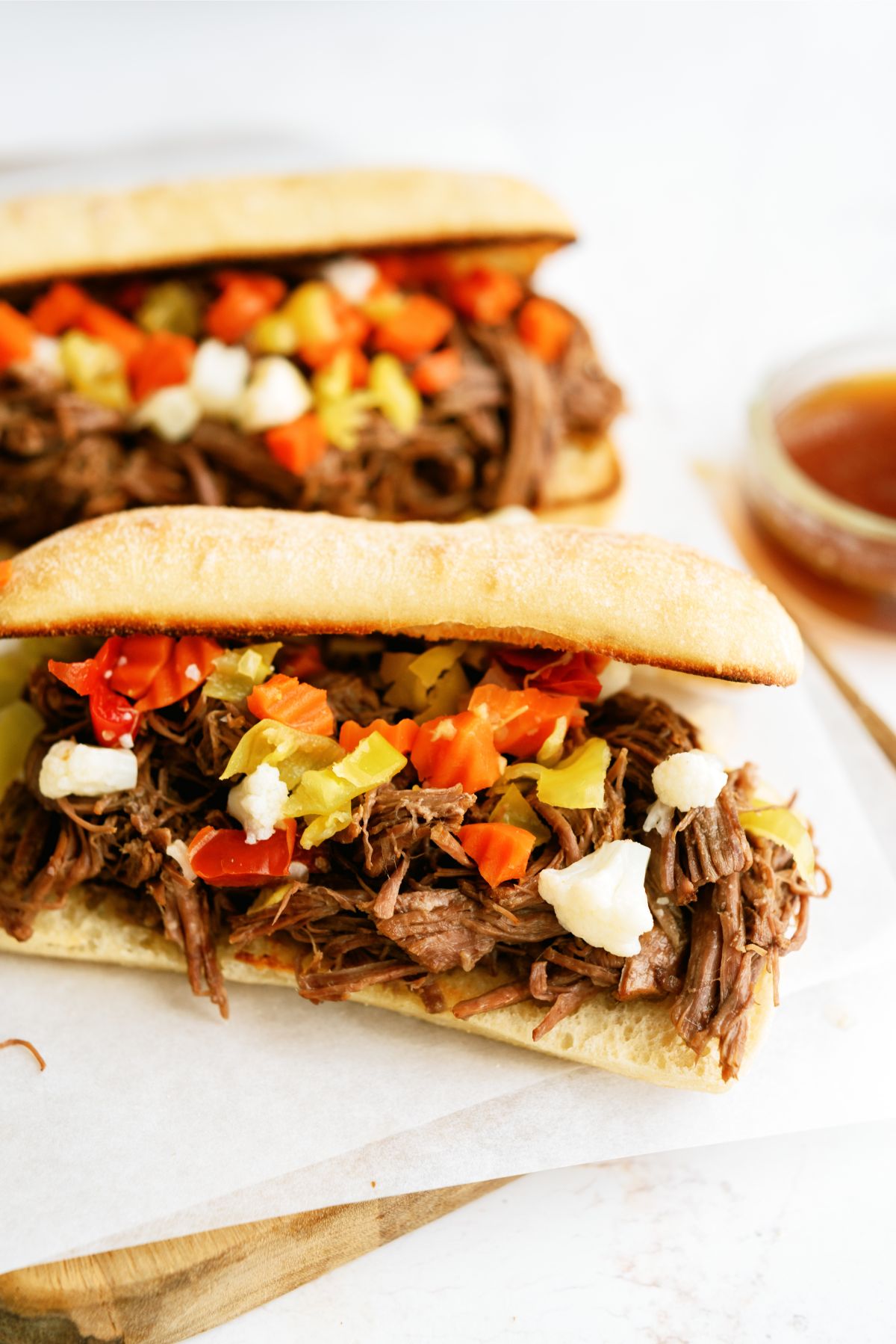 Two Instant Pot Chicago-Style Italian Beef Sandwiches on a cutting board