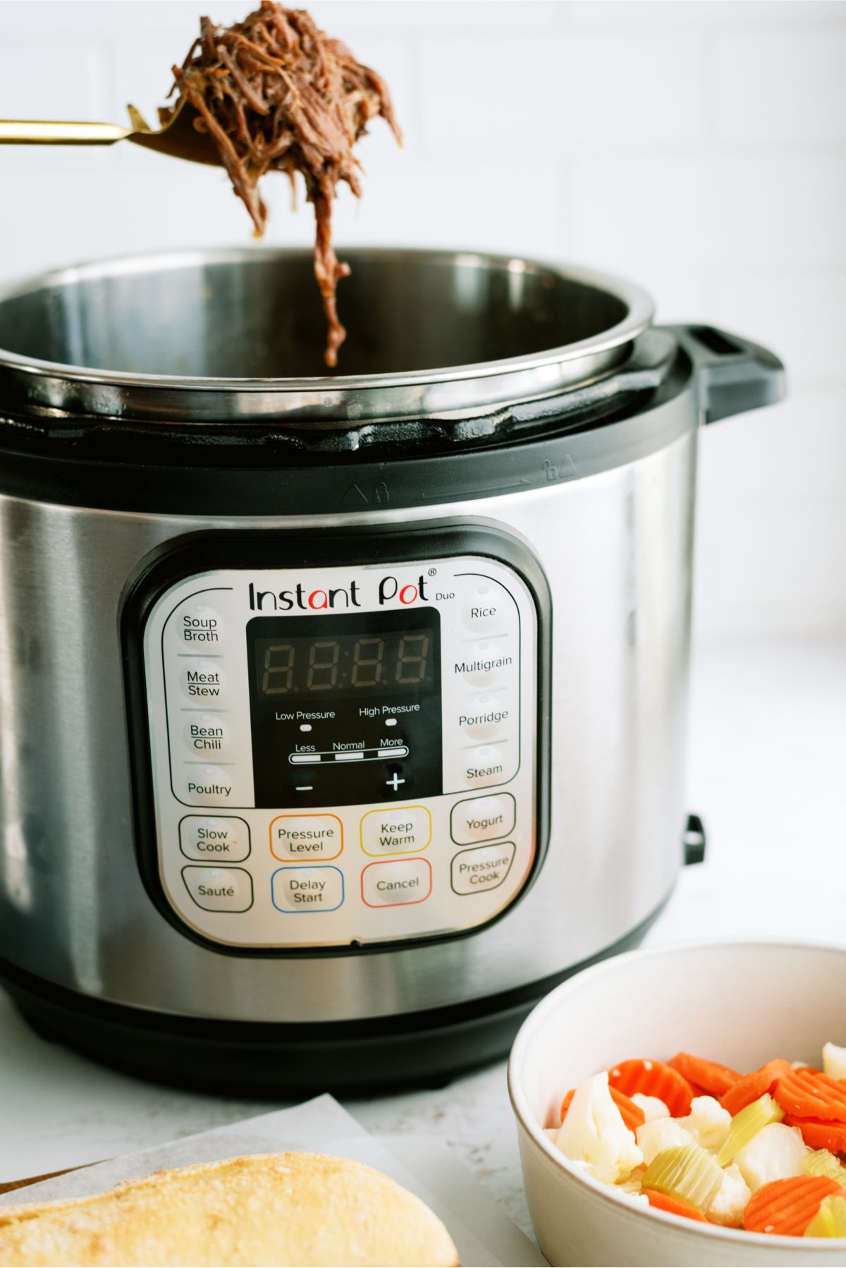 Instant pot with a spoon full of Instant Pot Chicago-Style Italian Beef 
