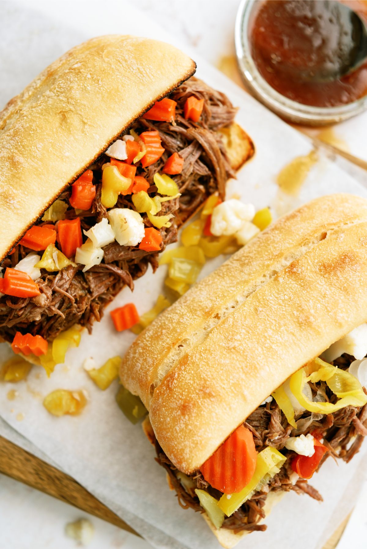2 Instant Pot Chicago-Style Italian Beef Sandwiches on a cutting board