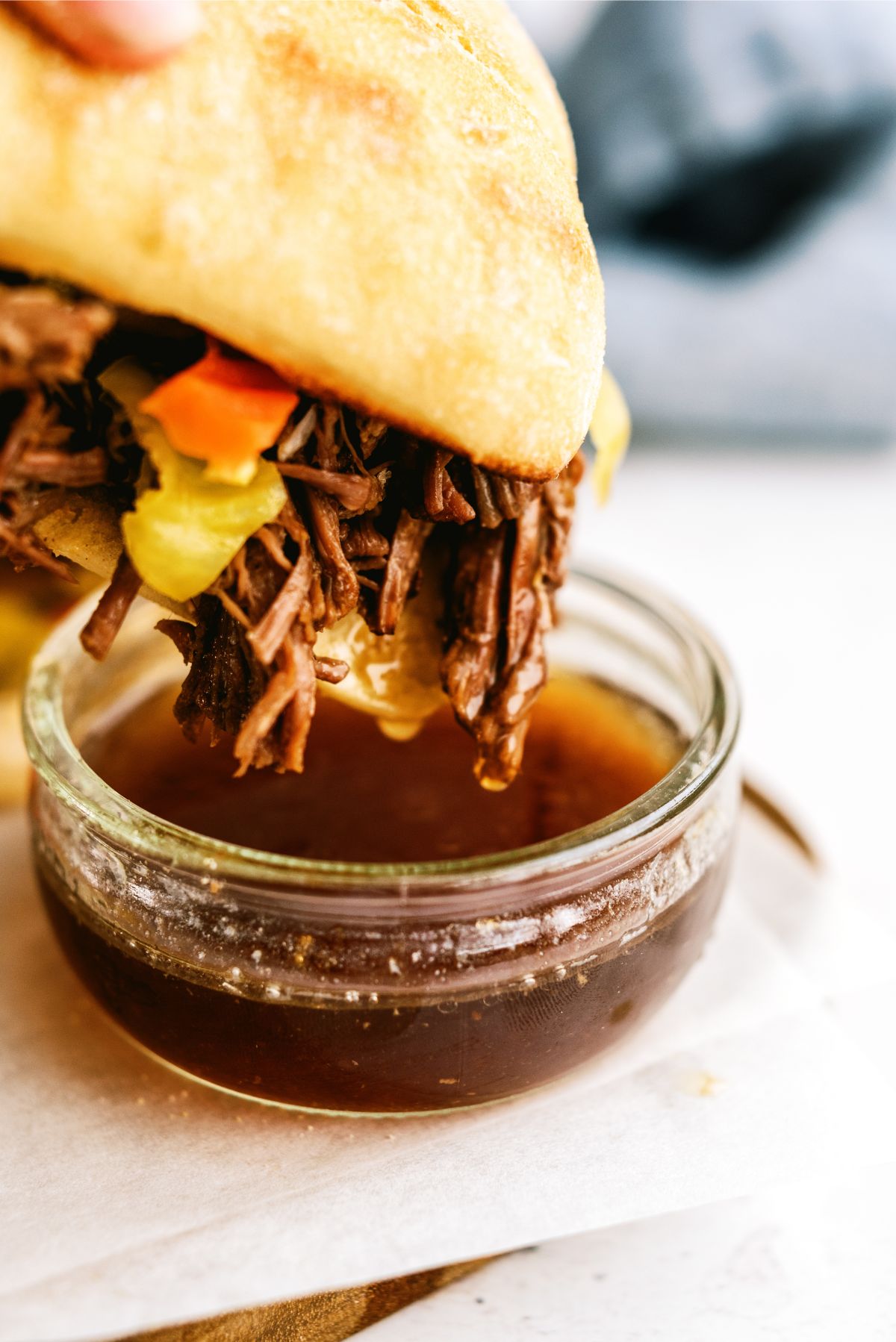 Dipping a Instant Pot Chicago-Style Italian Beef Sandwich in juice
