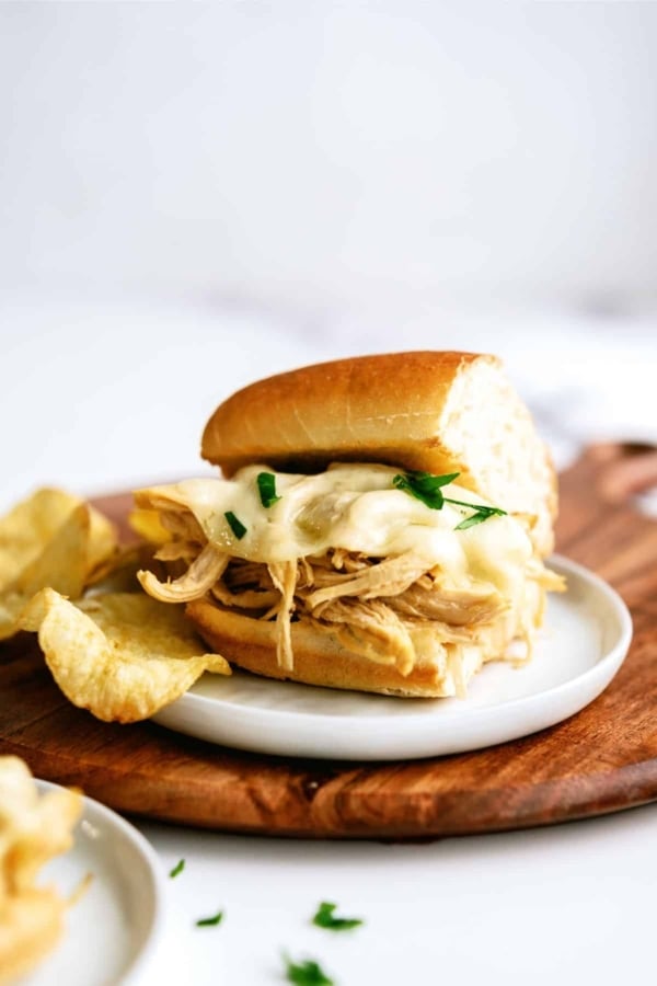 instant pot chicken french dip sandwiches on a plate with chips