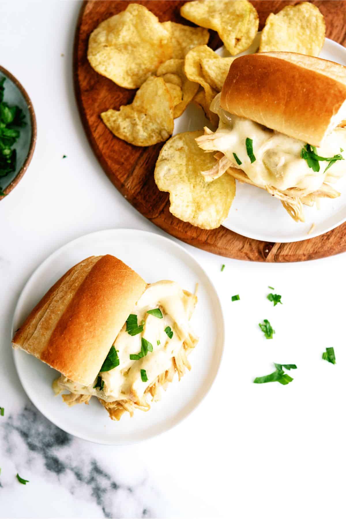 Top view of a Instant Pot Chicken French Dip Sandwich on a plate with chips