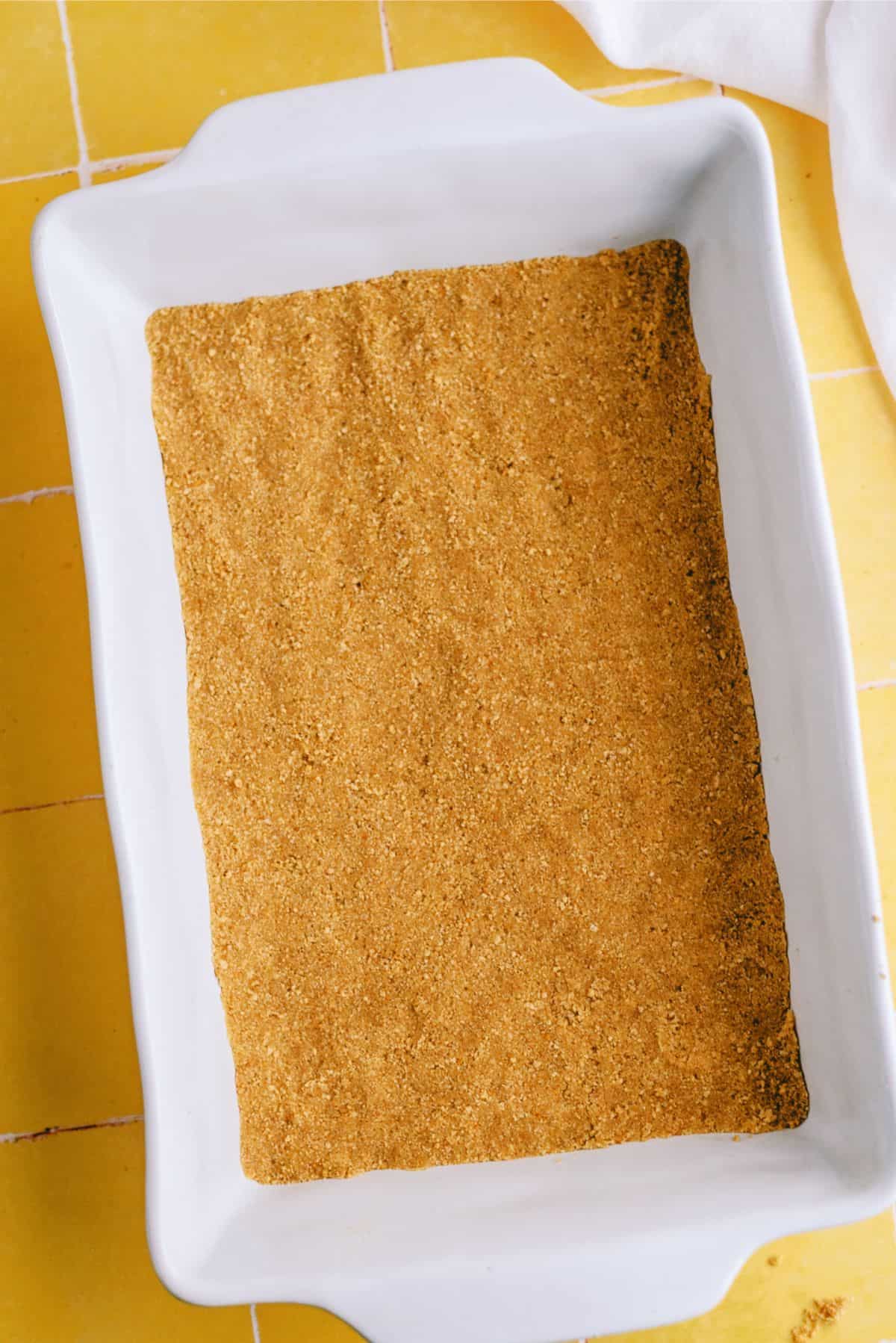 Graham cracker crust pressed into baking dish