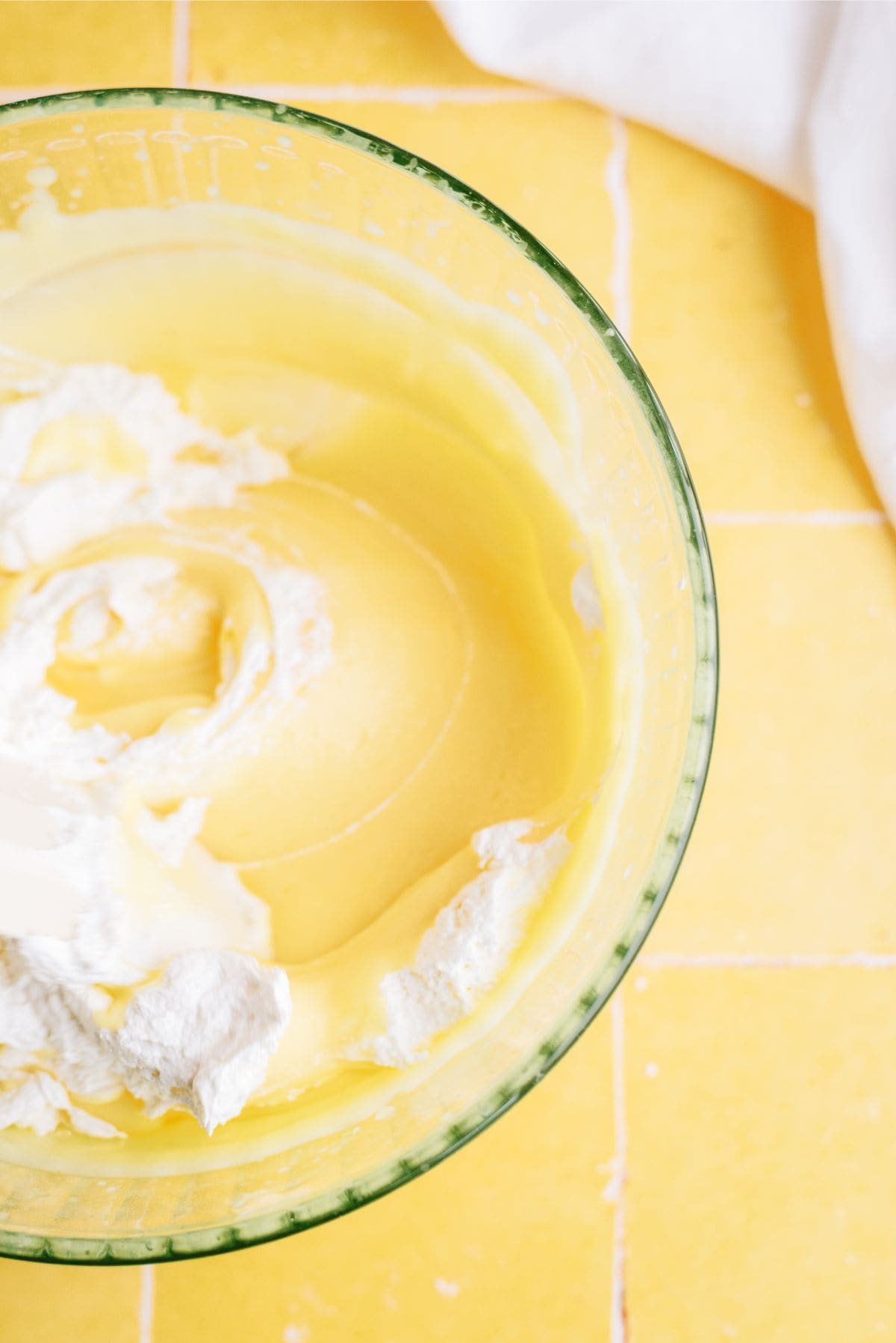 Adding whip cream to pudding mixture in mixing bowl