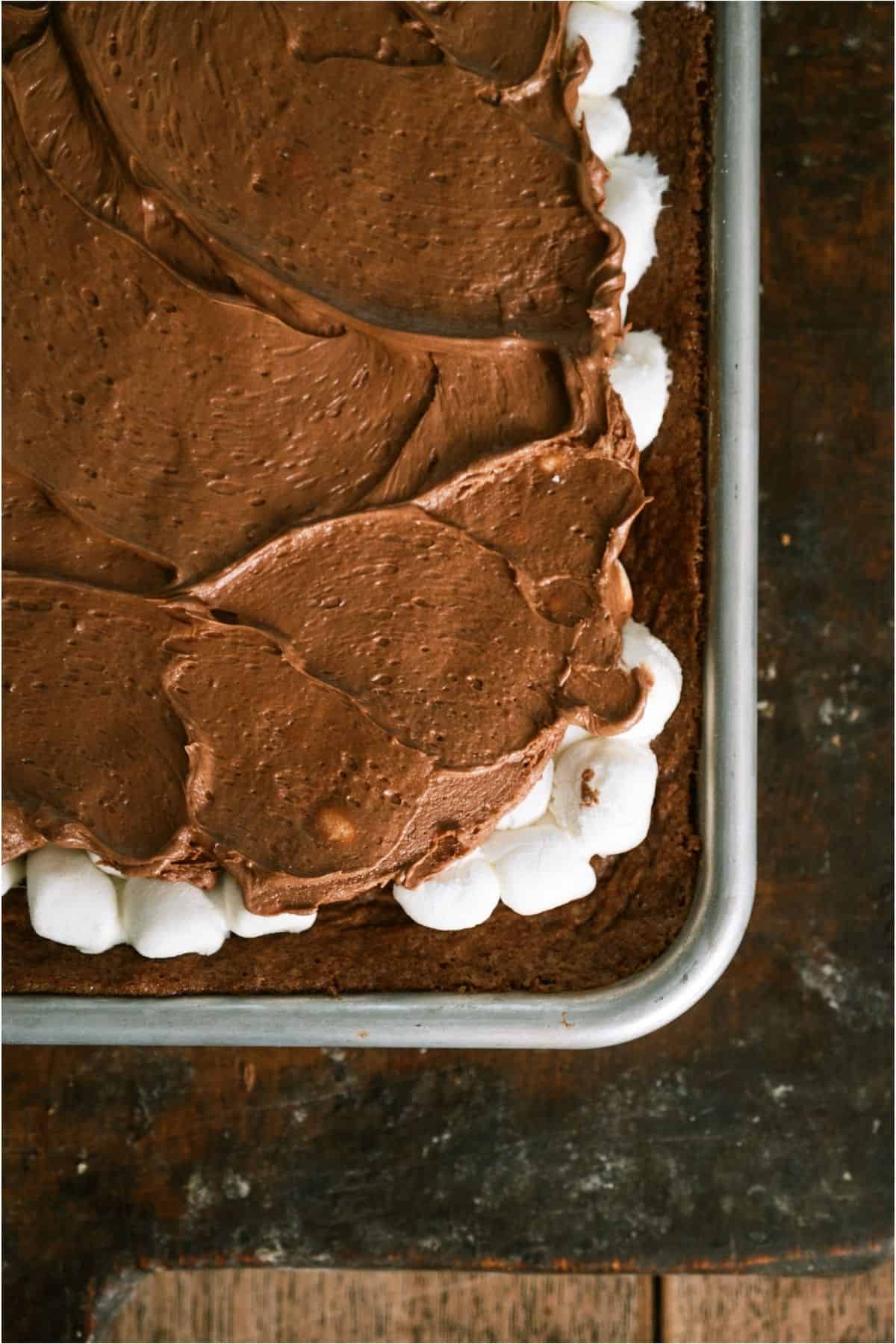 Top view of a pan of frosted Mom's Famous Chocolate Marshmallow Brownies.