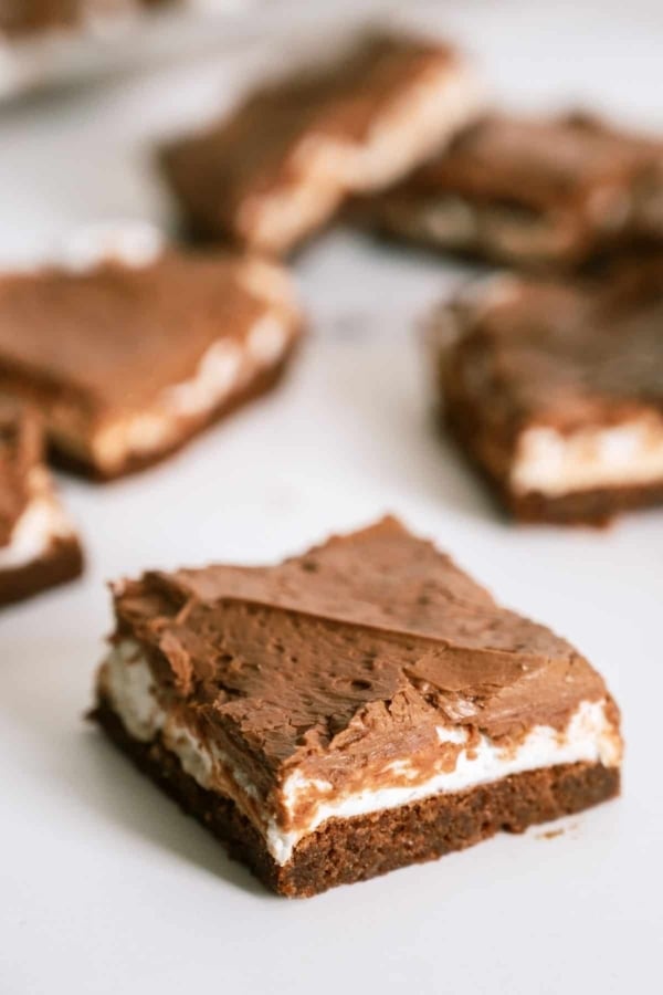 Mom's Famous Chocolate Marshmallow Brownies cut into squares on a white background.