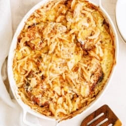 Top view of a Pork Chop Casserole With Hashbrowns in a baking dish with a spatula on the side.