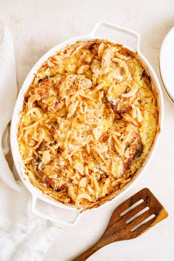 Top view of a Pork Chop Casserole With Hashbrowns in a baking dish with a spatula on the side.