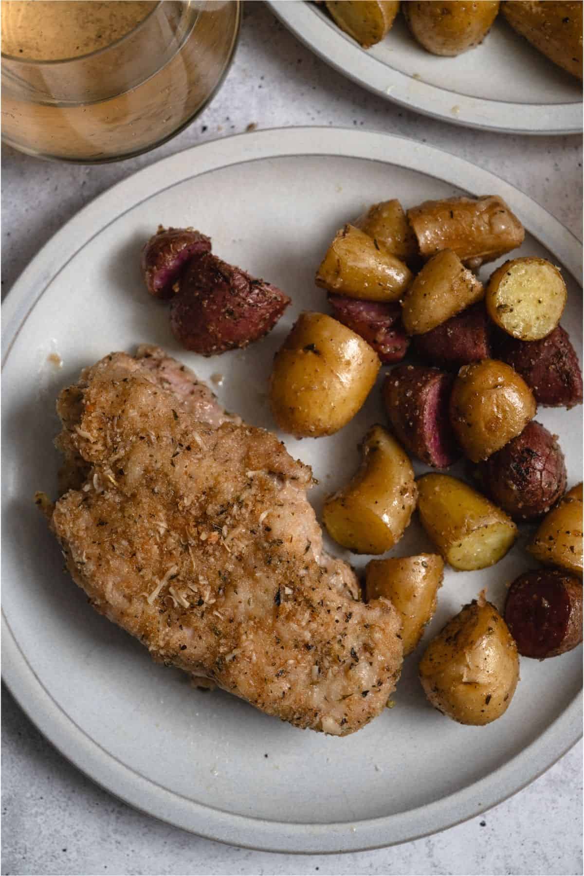 Sheet Pan Baked Pork Chop and Potatoes on a plate.