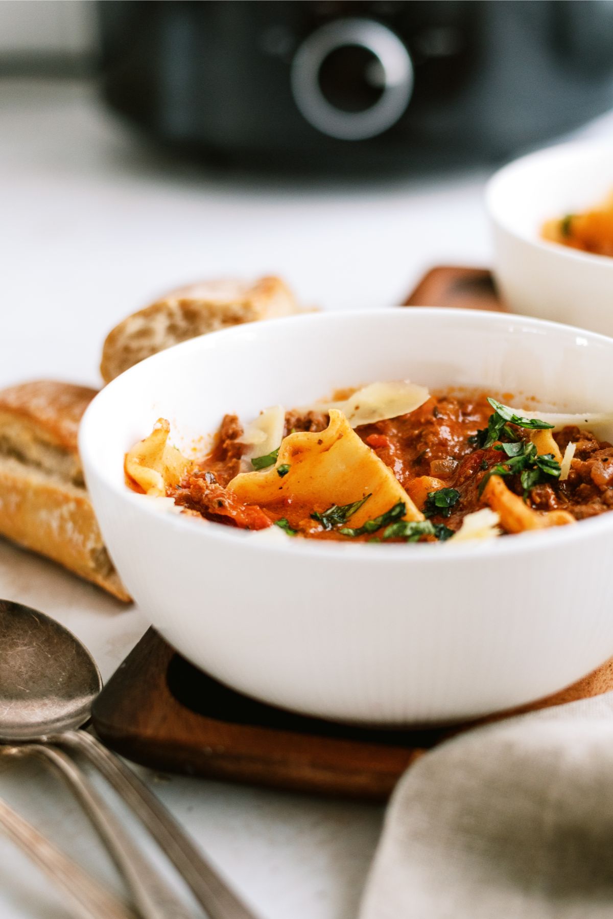 Side view of a bowl of Slow Cooker Beef Lasagna Soup