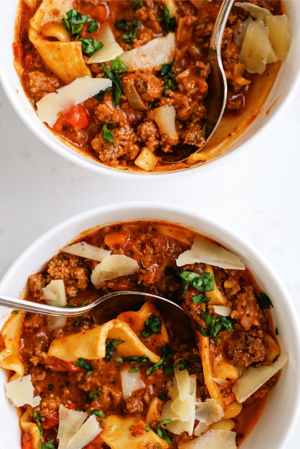 Two bowls of Slow Cooker Beef Lasagna Soup with spoons