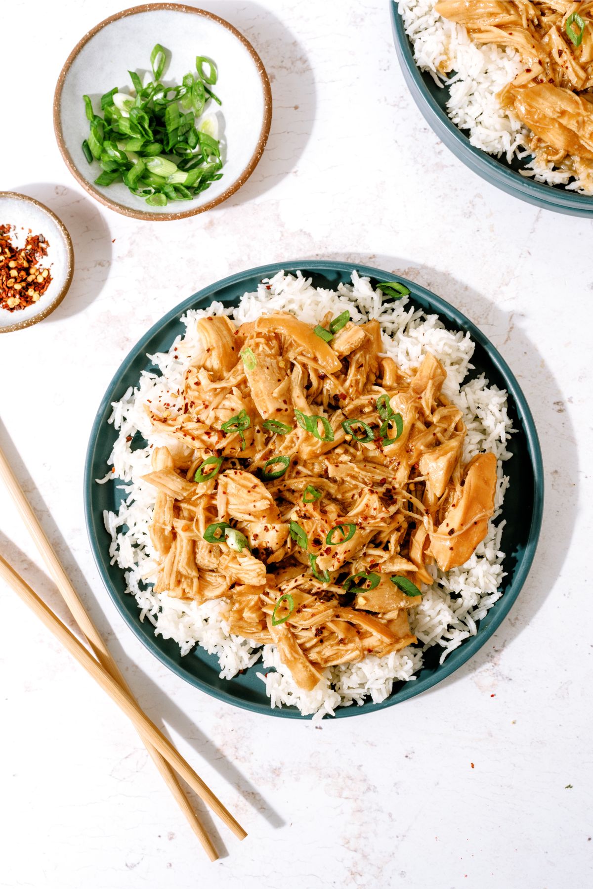 Slow Cooker Bourbon Chicken served on top of rice on a plate