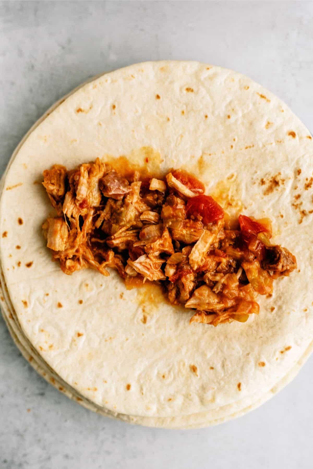 Chile Verde Shredded Pork in the center of tortilla 