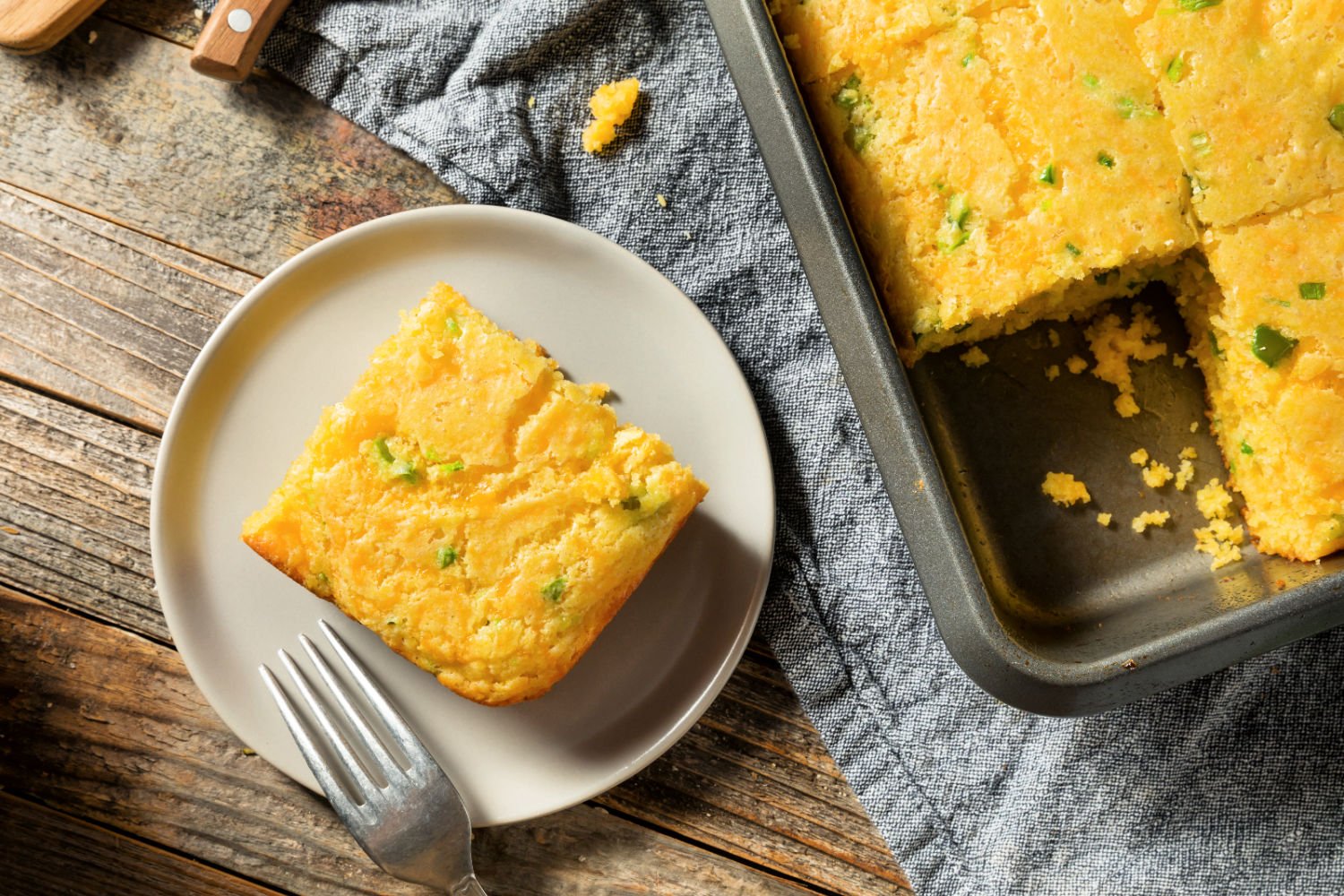 A slice Southwest cornbread on a plate with a fork