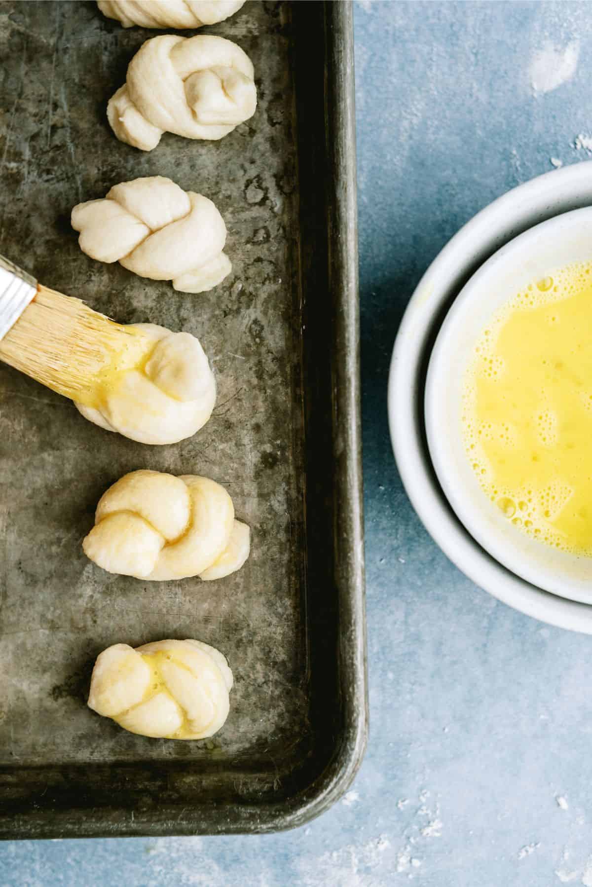 Unbaked pretzels brushed with egg and sprinkled with salt