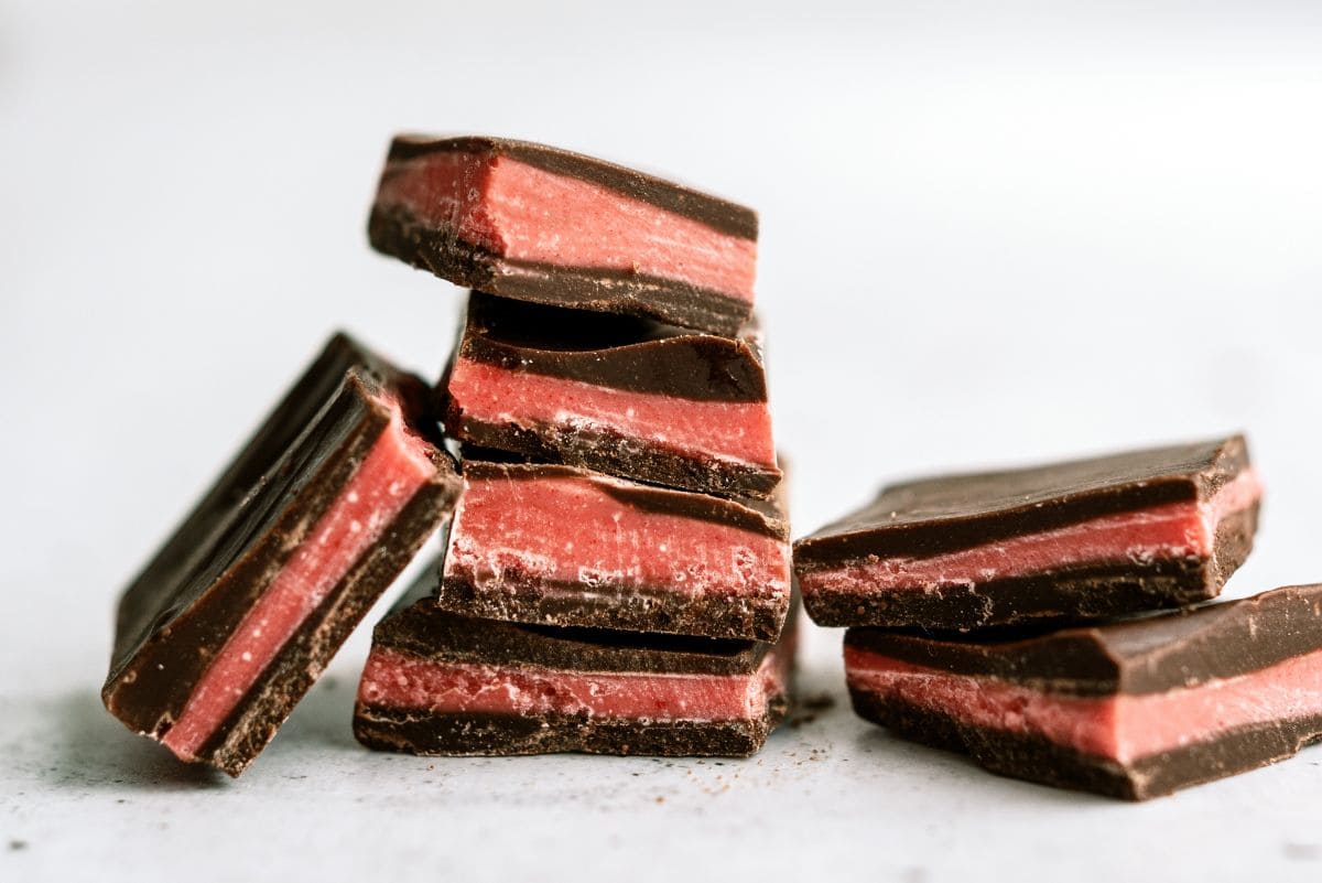Valentine's Thin Mints cut into squares and stacked in two rows with one mint tipping on the side.