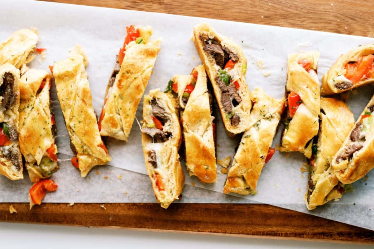 Sliced Cheesesteak Crescent Braid on a cutting board