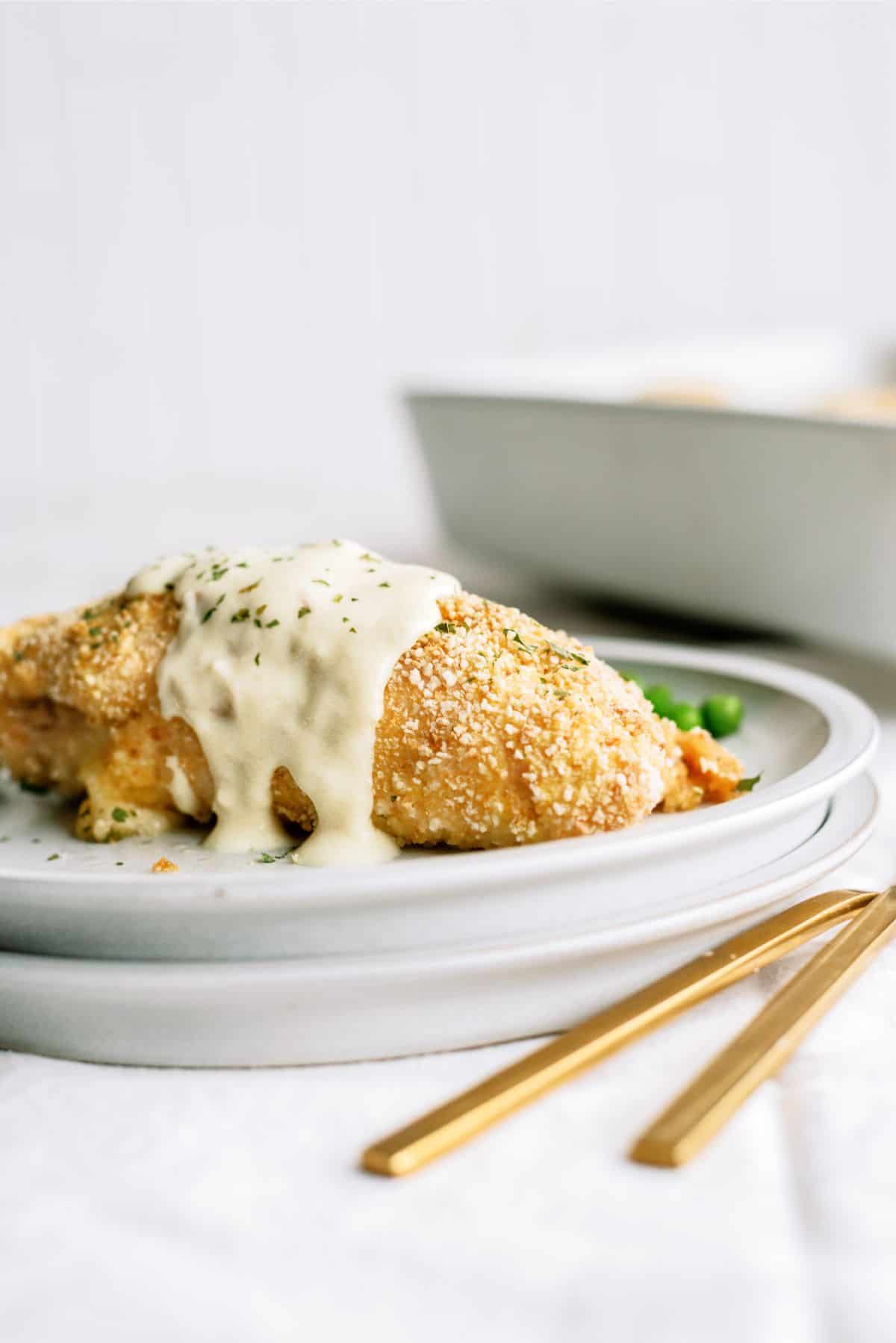 Easy Chicken Cordon Bleu on a plate topped with creamy Dijon sauce