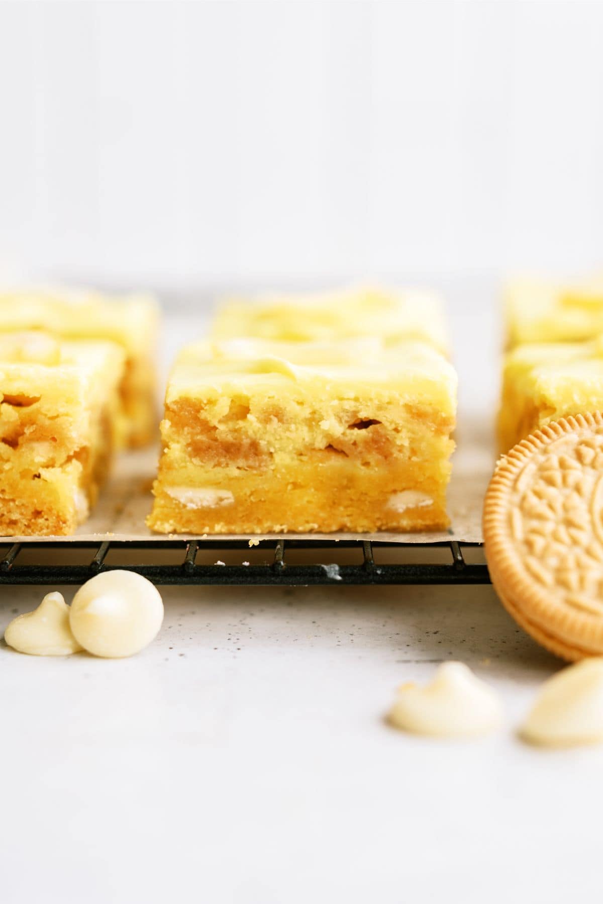 Side view of Lemon Cookie Cheesecake Bars on cooling rack