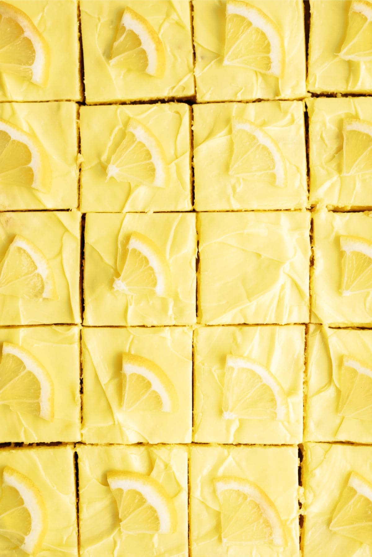 Close up of a pan of Lemon Cookie Cheesecake Bars cut into squares