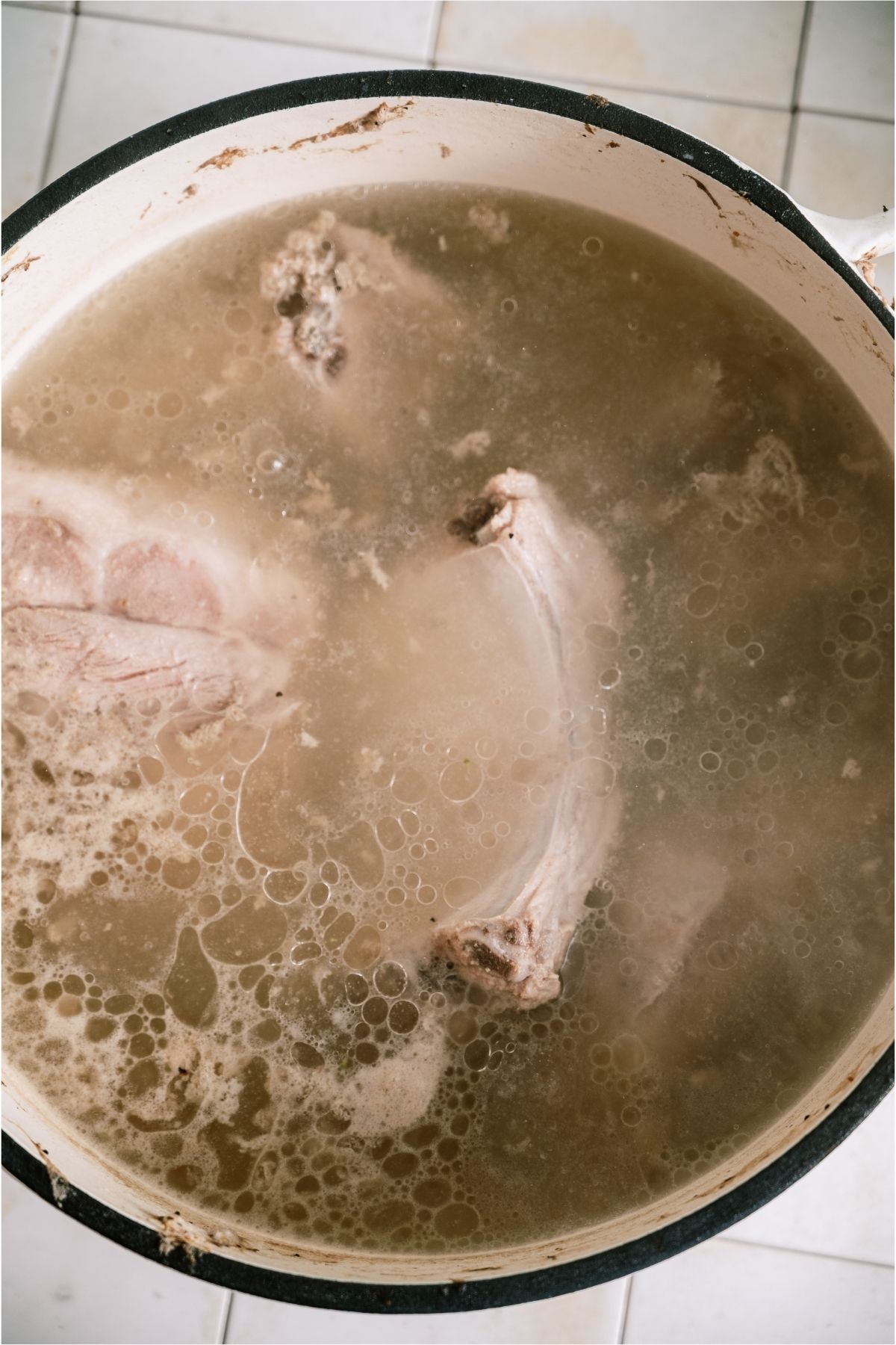 Rib sections in a boiling pot of water.