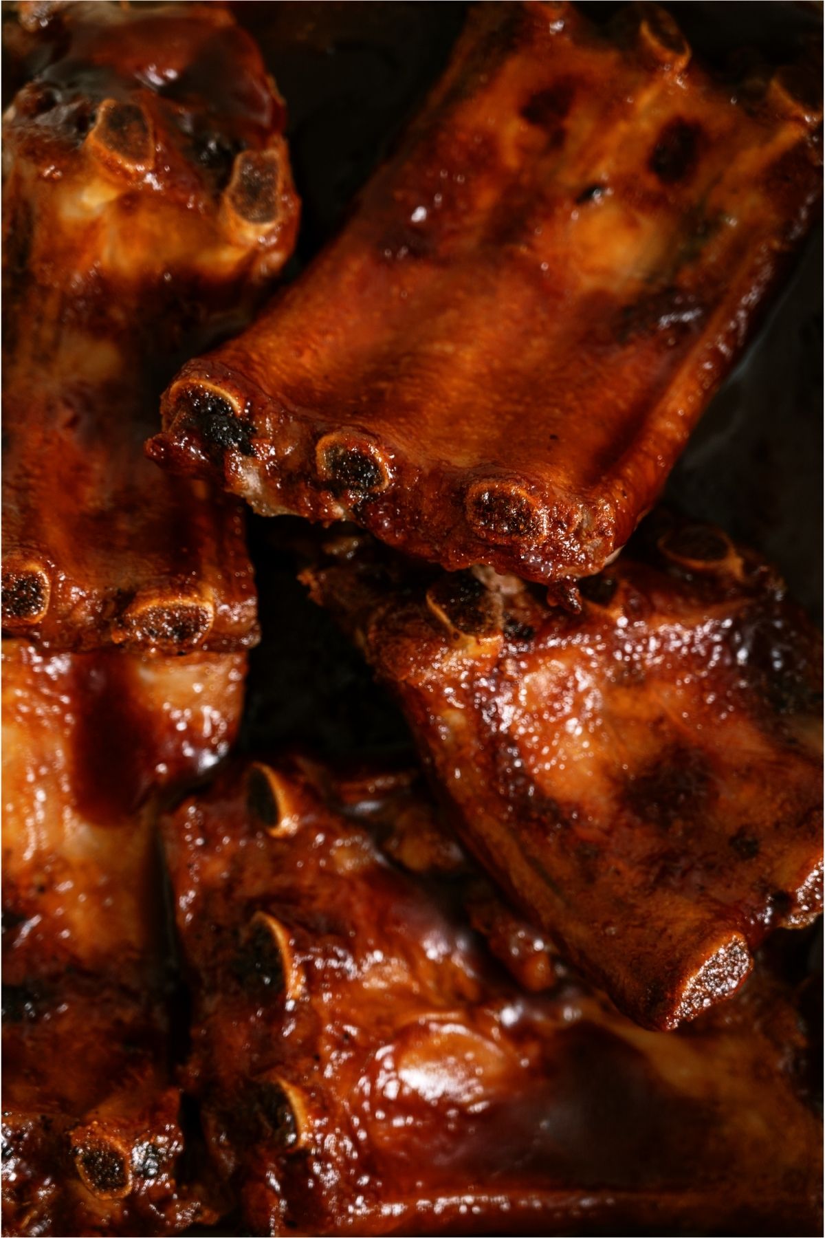 Close up of Oven Baked BBQ Ribs in a baking dish.
