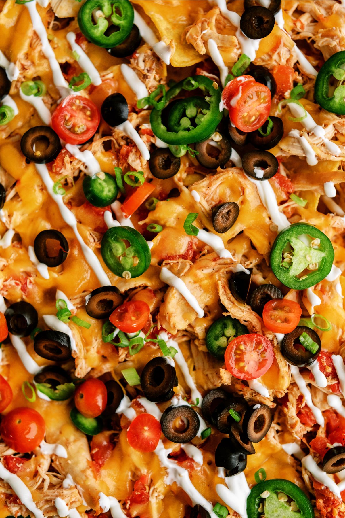 Close up of Slow Cooker Shredded Chicken Nachos with toppings