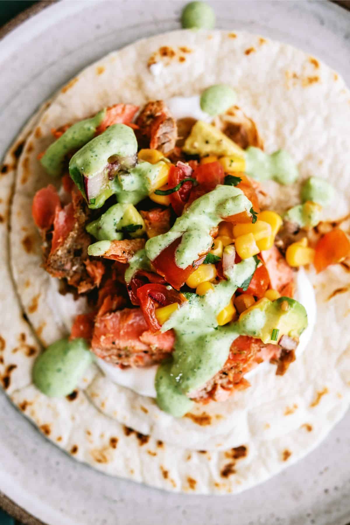 Close up of an open Blackened Salmon Taco on a plate