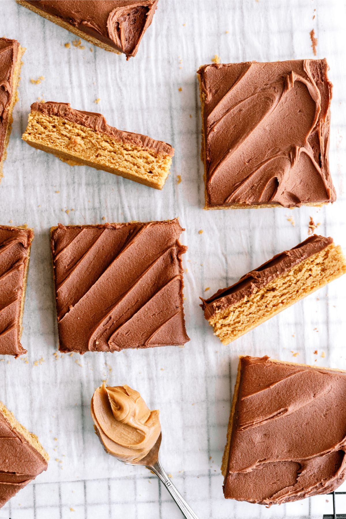 Cake Mix Peanut Butter Bars cut into squares with a spoonful of peanut butter