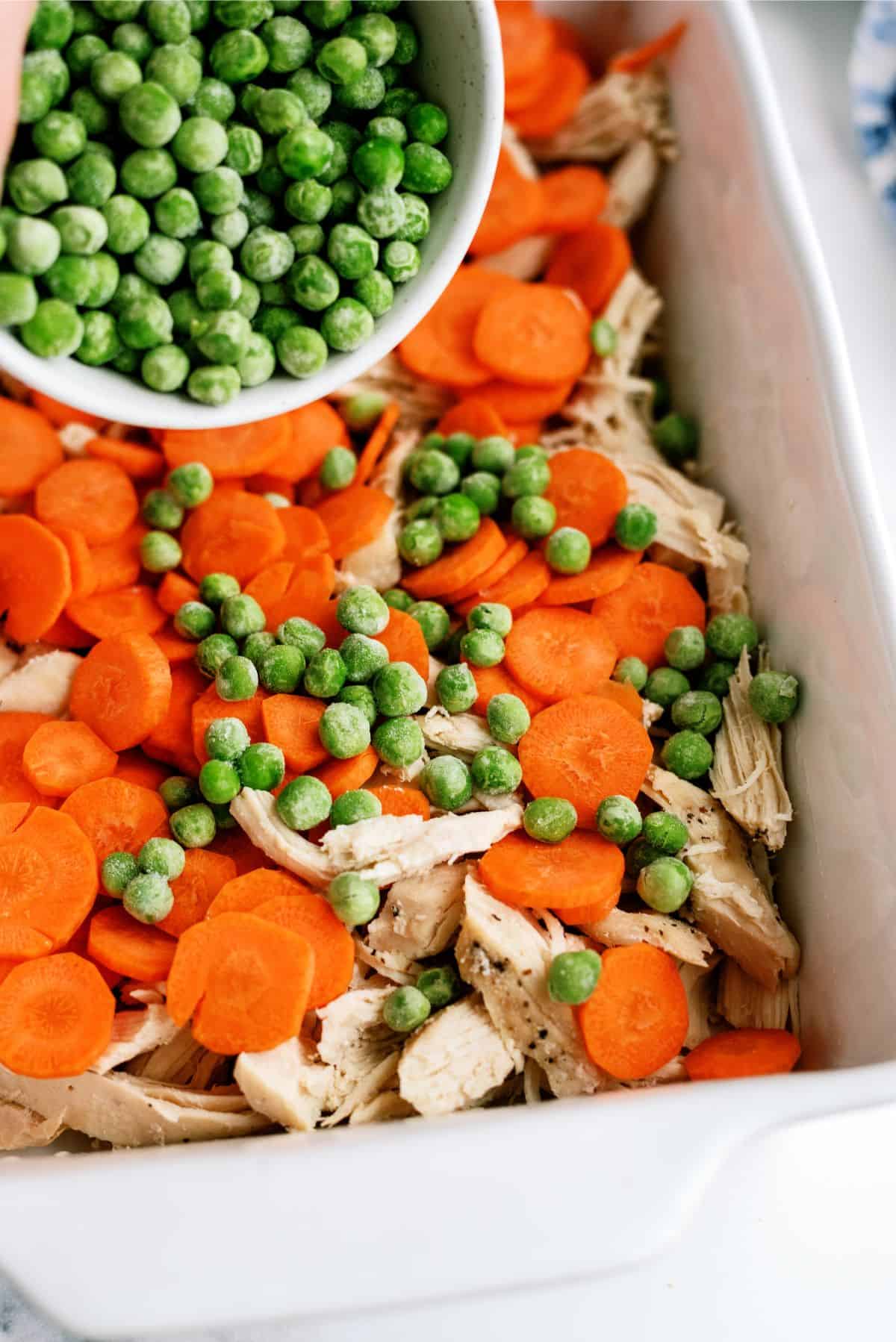 Layered veggies and chicken in a 9x13 baking dish