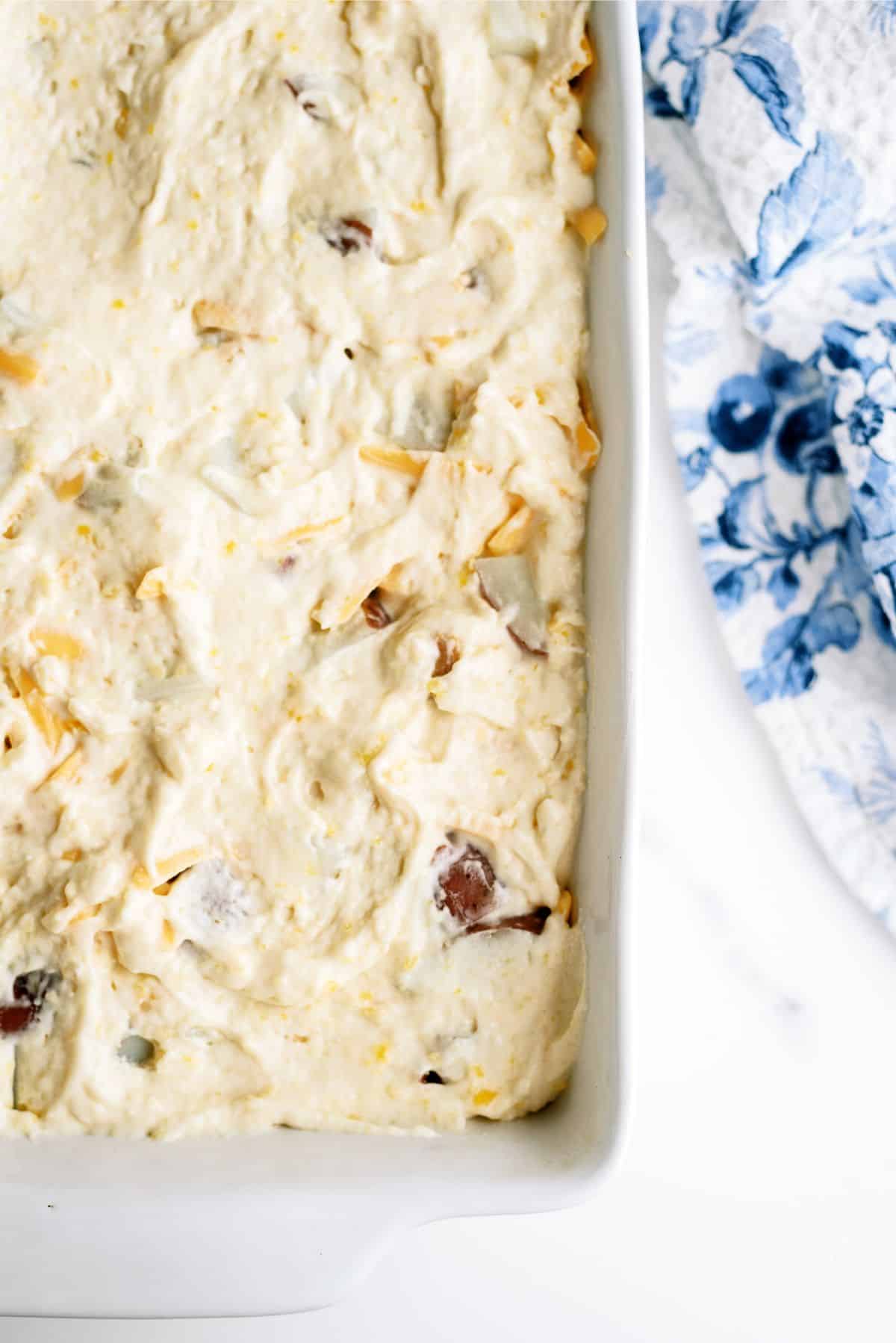 Biscuit mixture spread on top of unbaked casserole