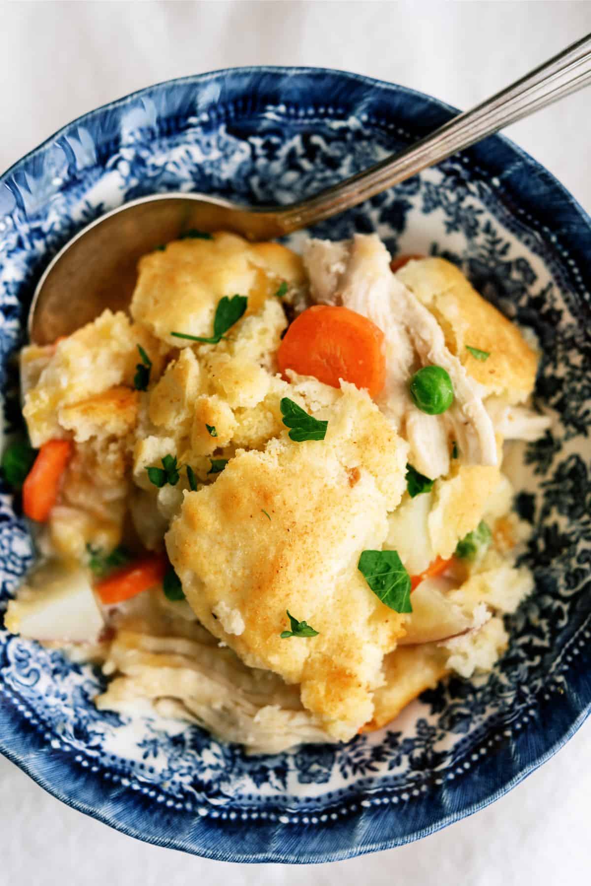 Close up of a serving of Cheesy Chicken Pot Pie in a bowl with a spoon