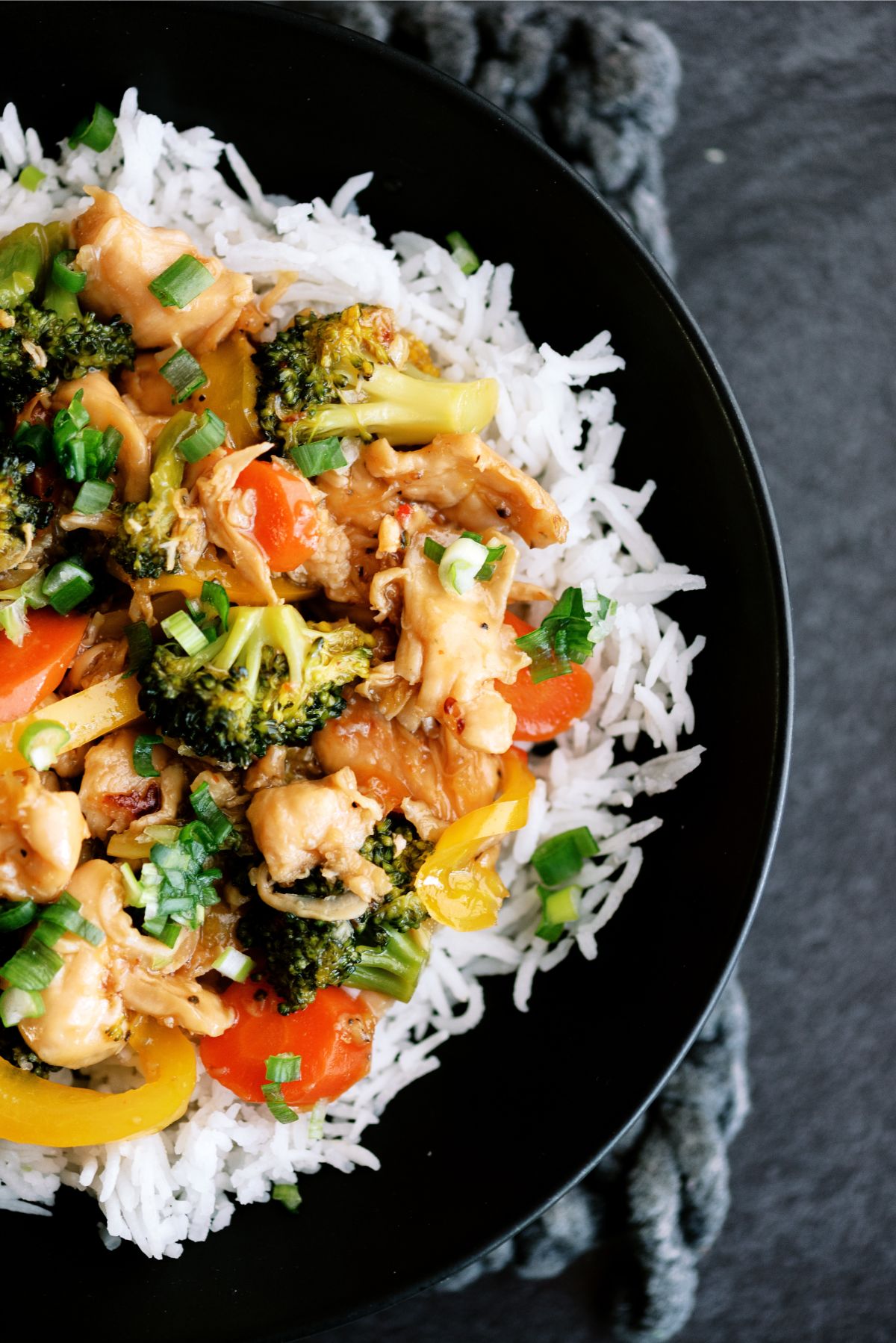 Instant Pot Chicken and Veggie Stir Fry served over rice on a plate