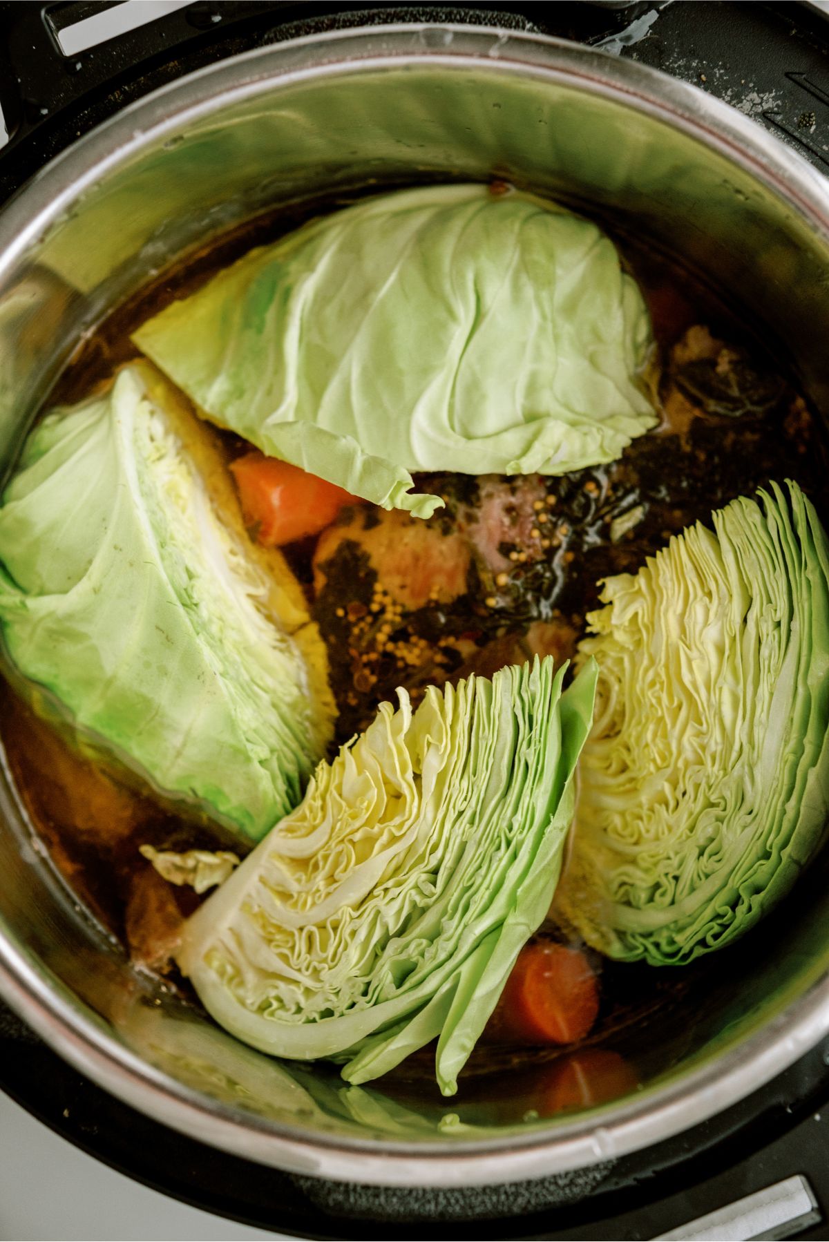 Cabbage wedges in Instant Pot on top of Beef and Veggies