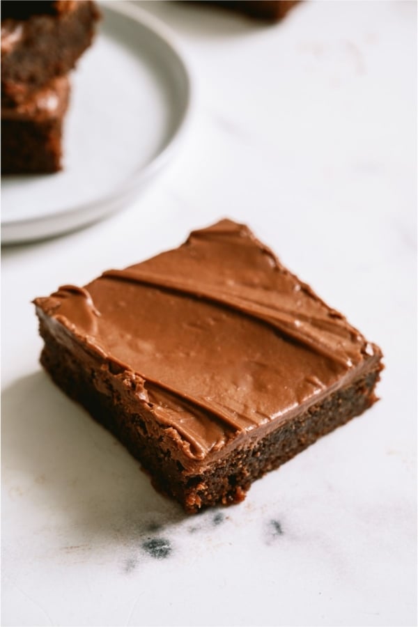 A Frosted Chocolate Lunch Lady Brownie on a white background.