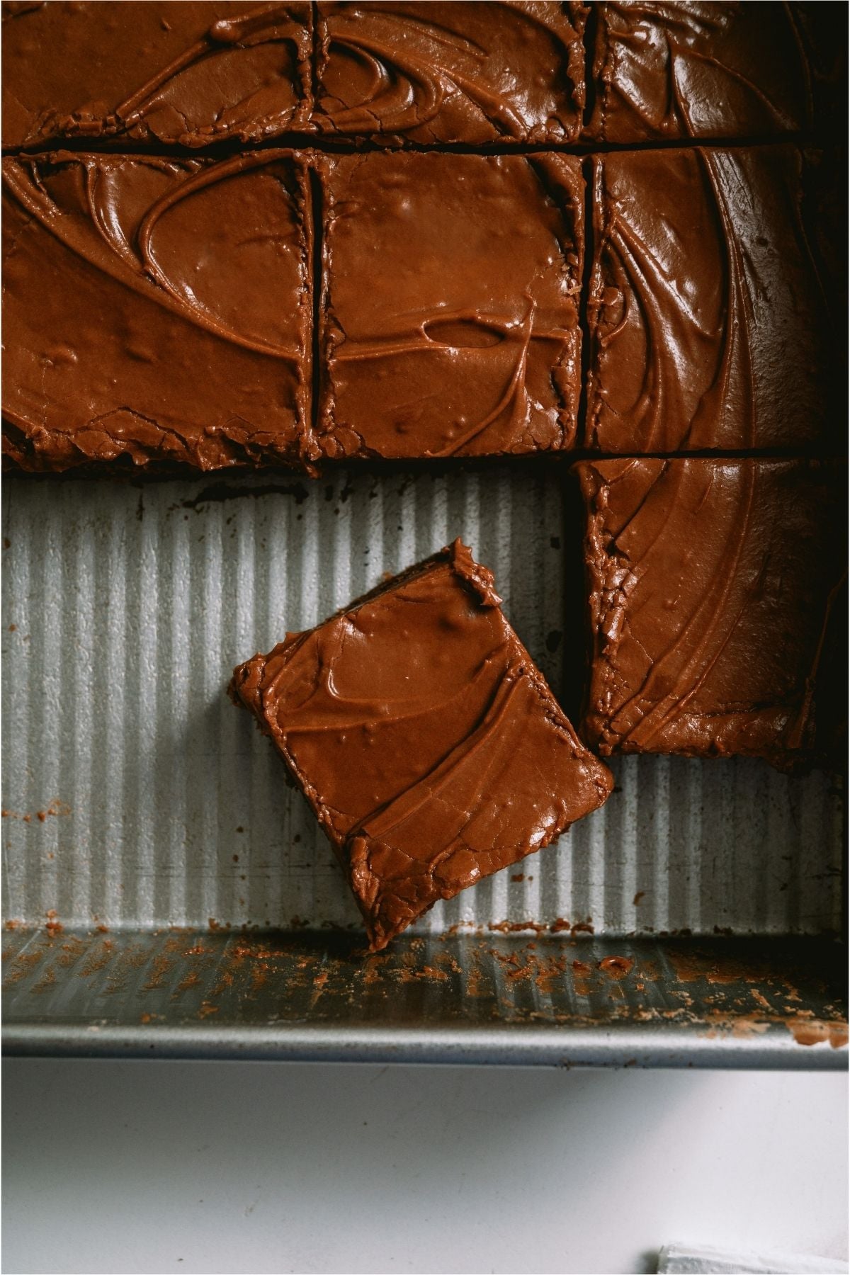 Lunch Lady Brownies cut into squares with some missing inside pan.