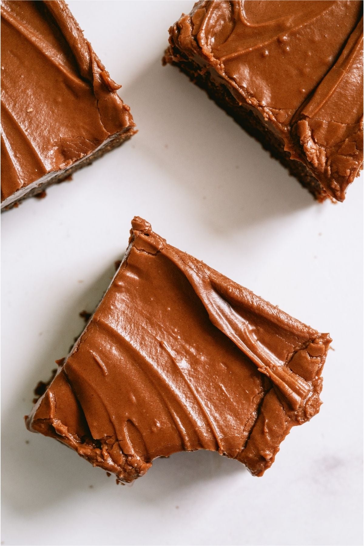 Three Lunch Lady Brownies with one missing a bite.