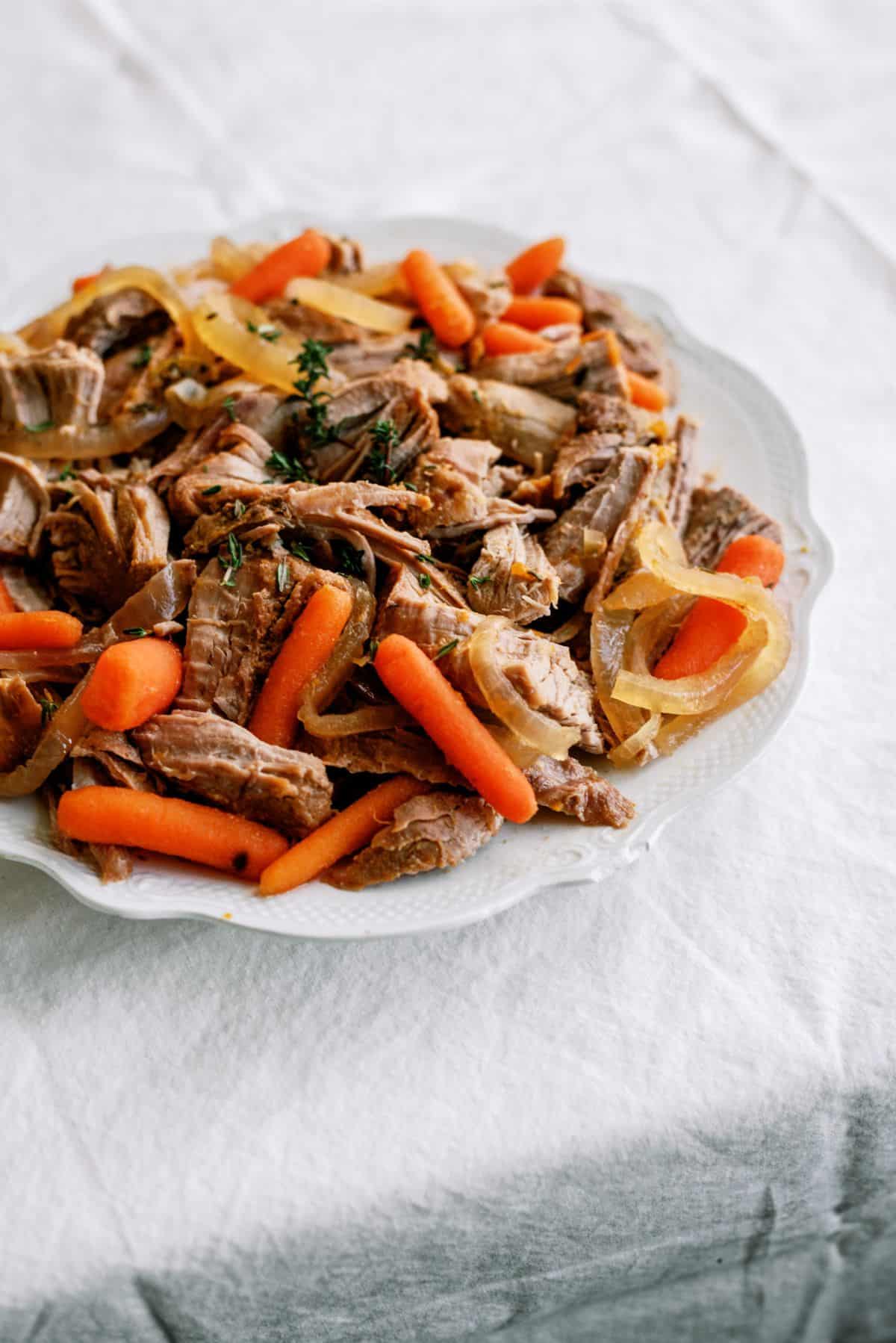 Slow Cooker Apricot Glazed Pork shredded on a plate