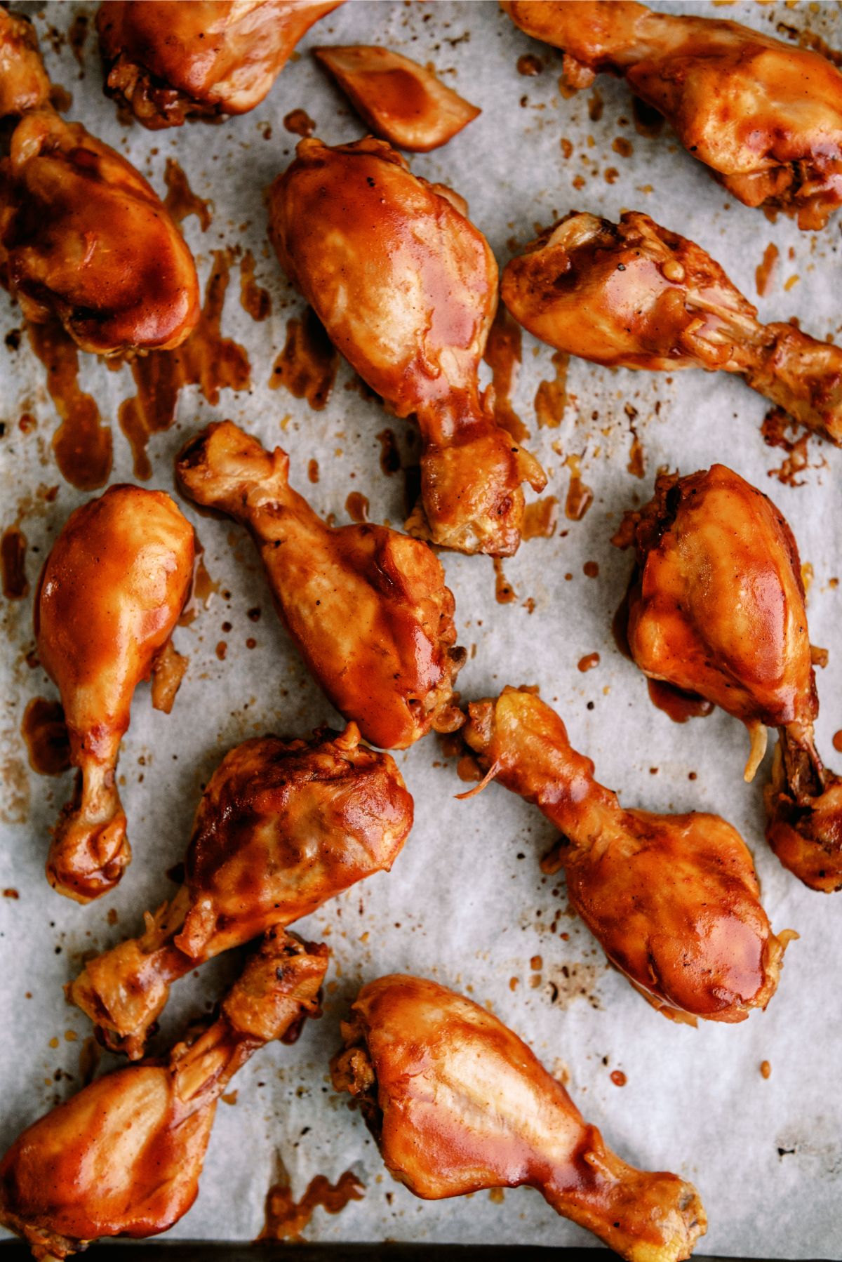 Slow Cooker BBQ Chicken Drumsticks separated on a baking sheet