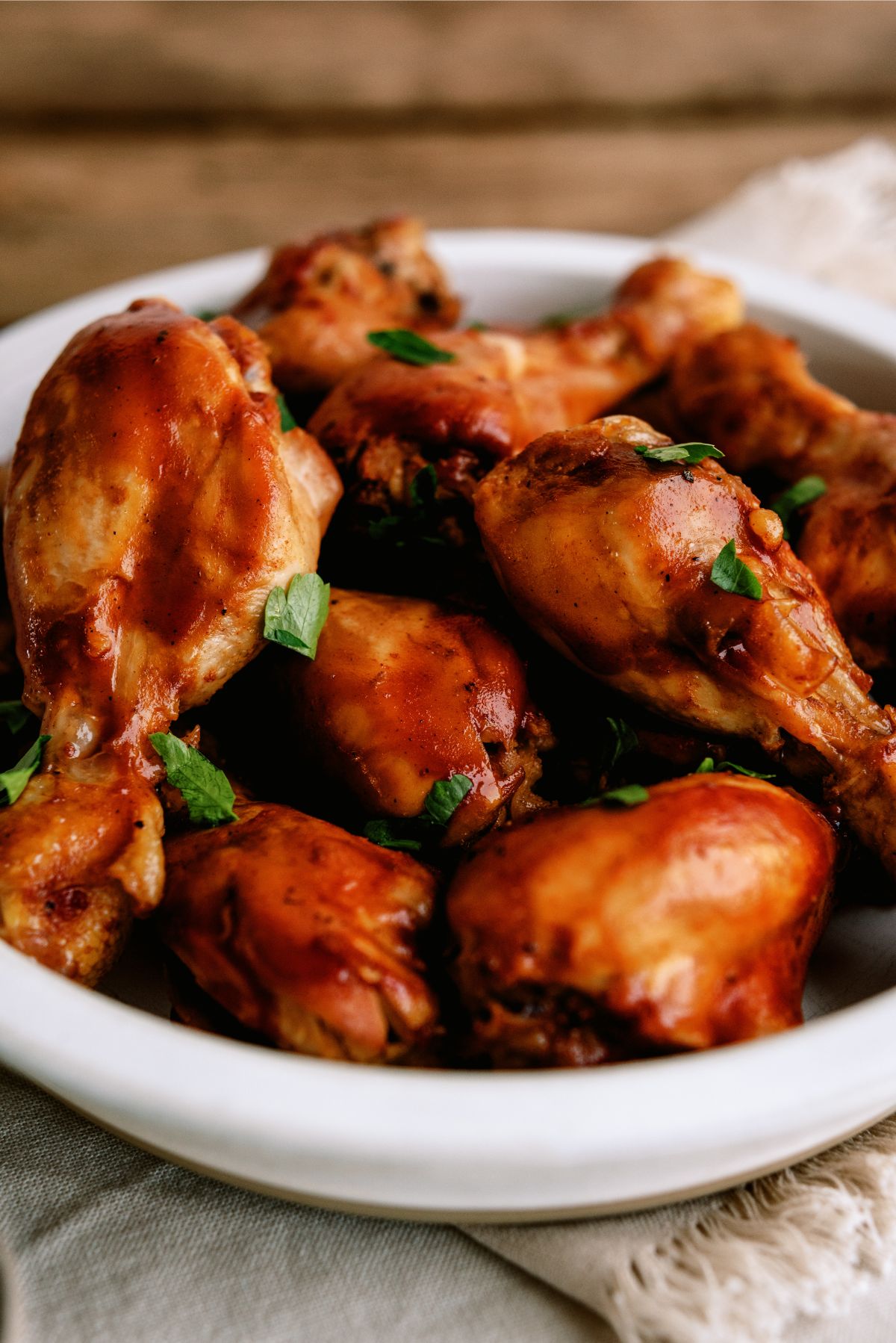 Close up of a bowl of Slow Cooker BBQ Chicken Drumsticks