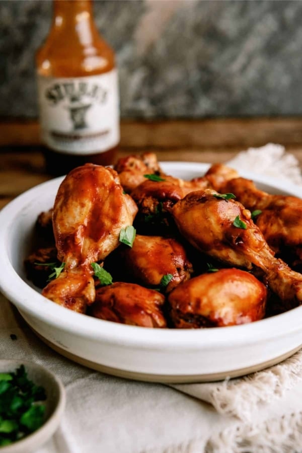 slow cooker bbq chicken drumsticks on a white plate