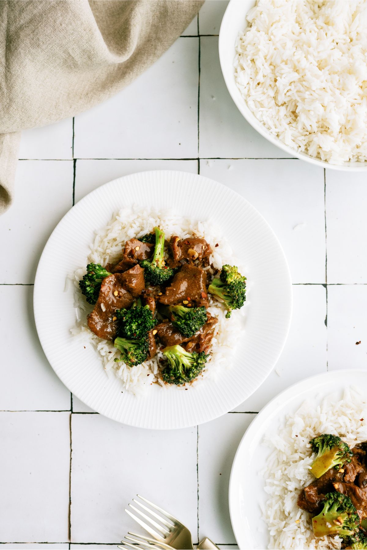 A serving of Slow Cooker Beef and Broccoli on a plate over rice