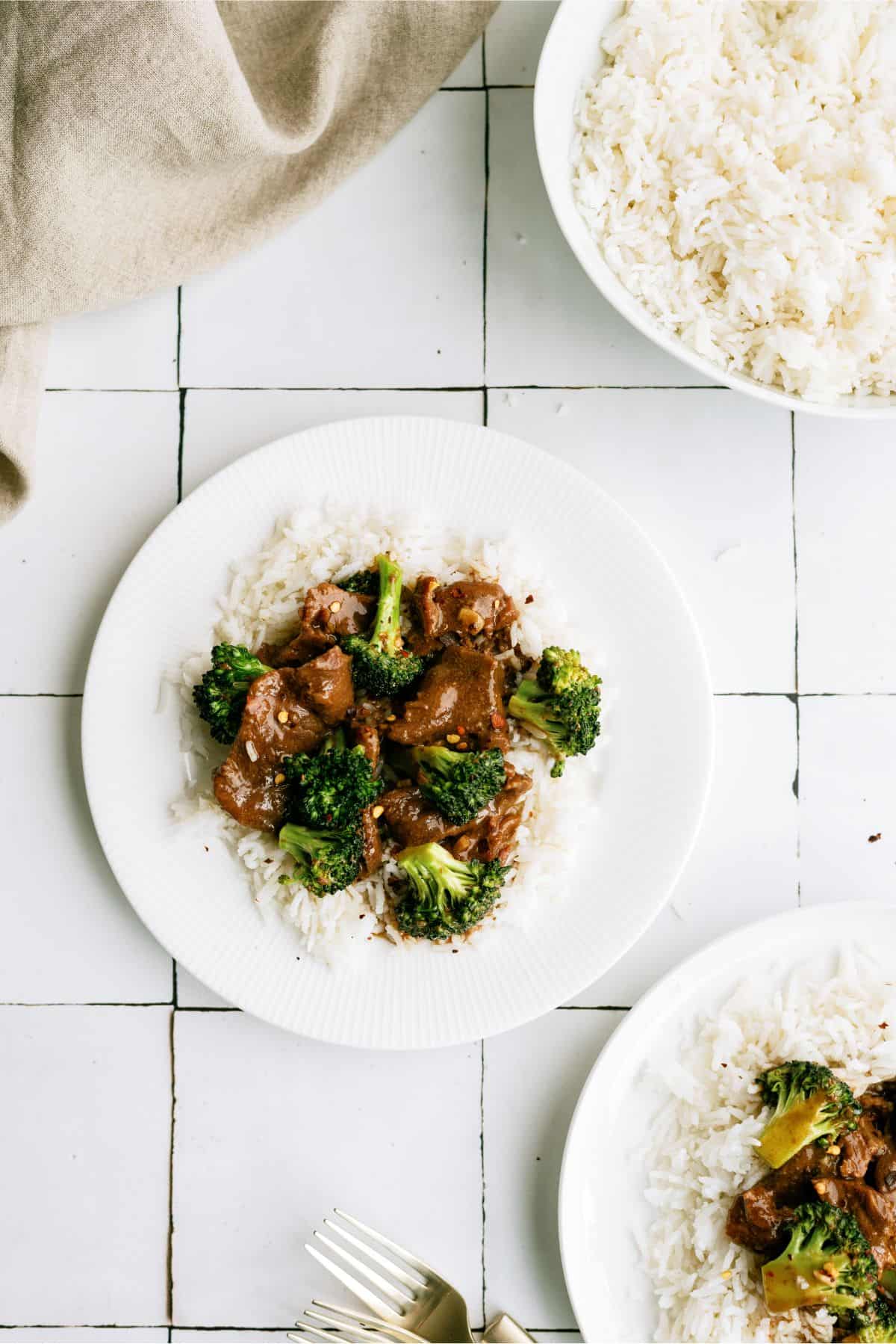 A serving of Slow Cooker Beef and Broccoli on a plate over rice