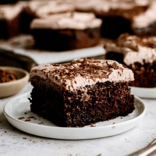 Slices of Hot Fudge Chocolate Poke Cake on plates.