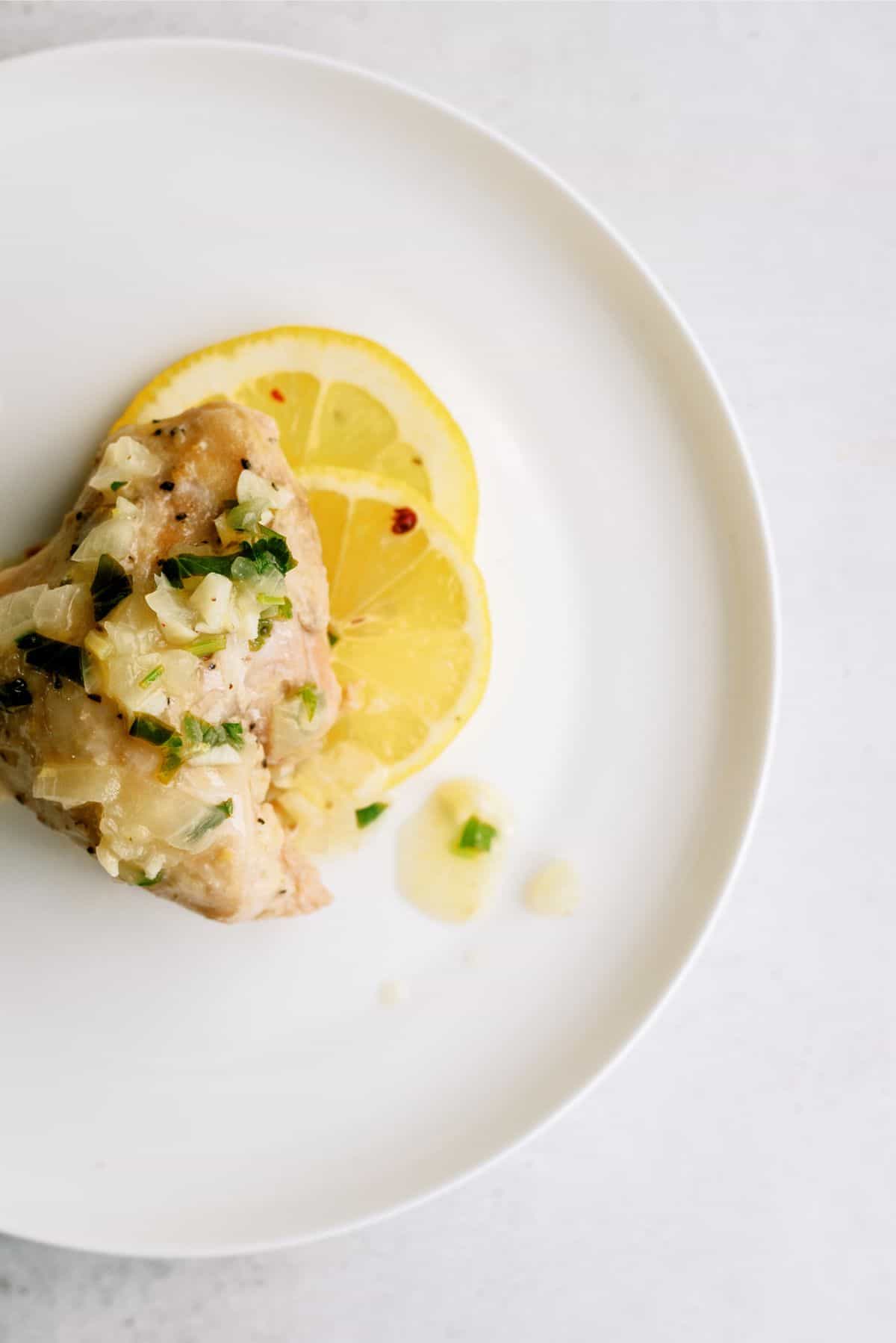 A serving of Instant Pot Chicken Thighs with Lemon Pepper Glaze on a plate.