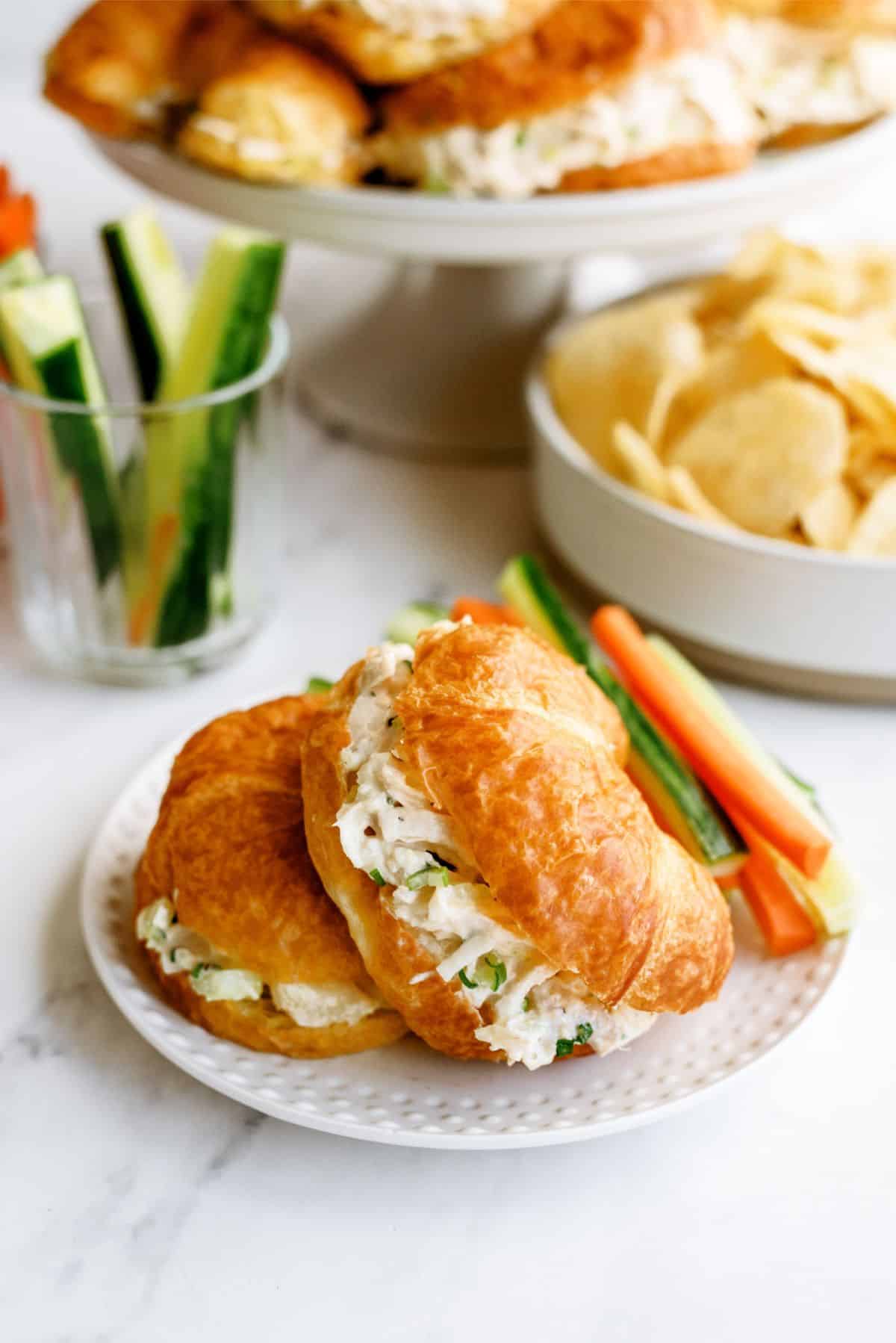 2 Pineapple Chicken Salad Sandwiches on a plate with sliced veggies