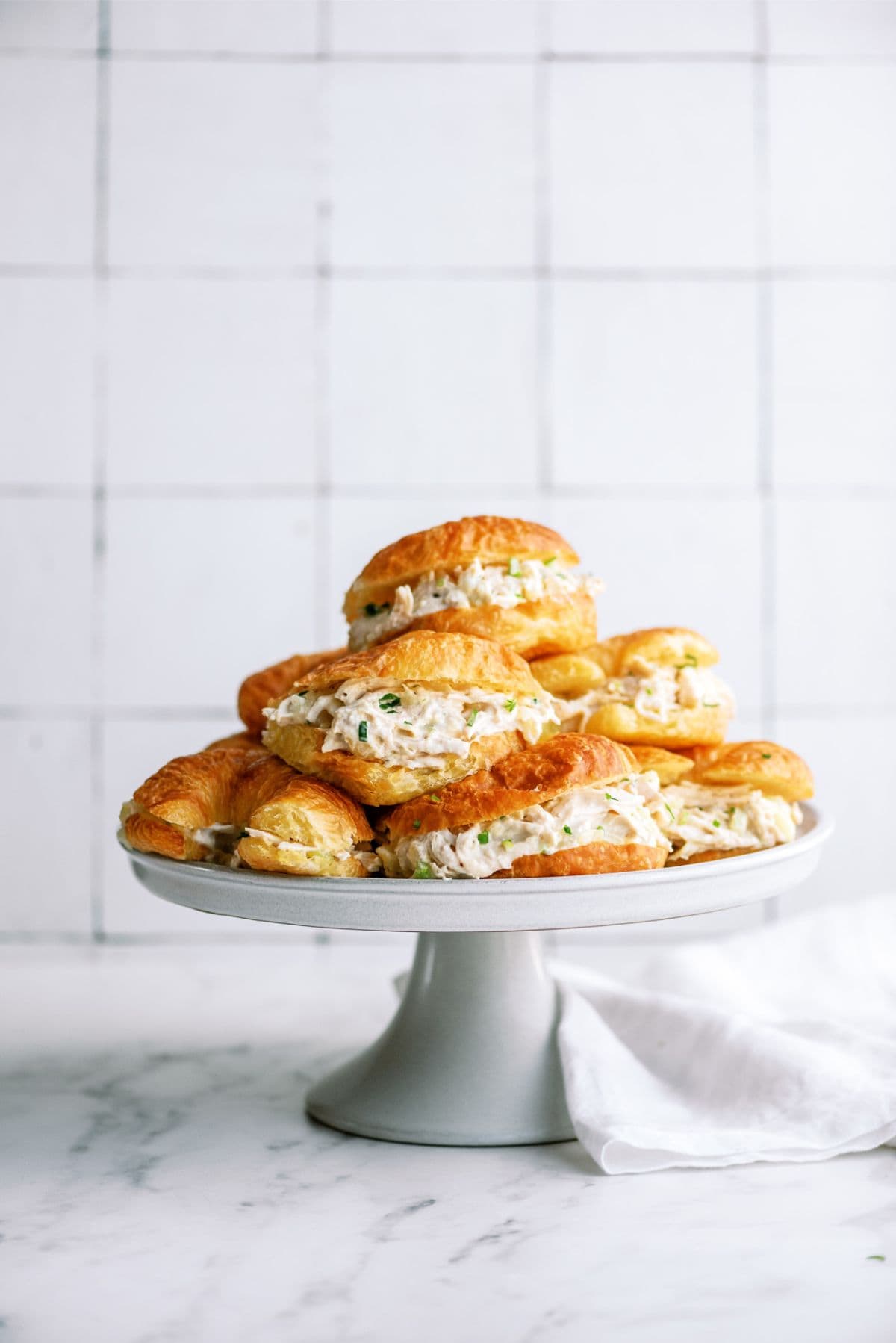 Pineapple Chicken Salad Sandwiches stacked on a stand