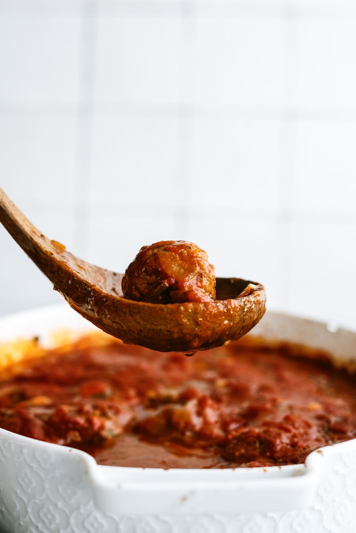 One Porcupine Meatball on a wooden spoon