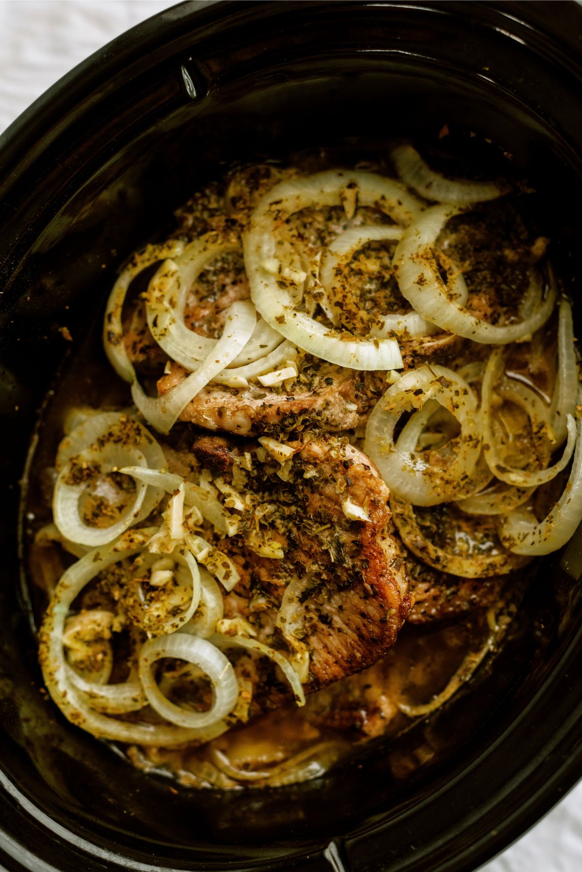 Pork chops and onion cooked in a slow cooker