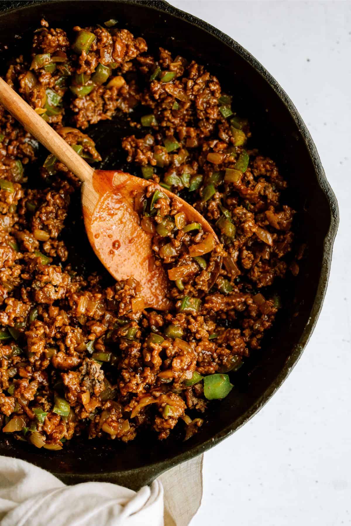 BBQ Sloppy Joe Mixture in a skillet with a wooden spoon